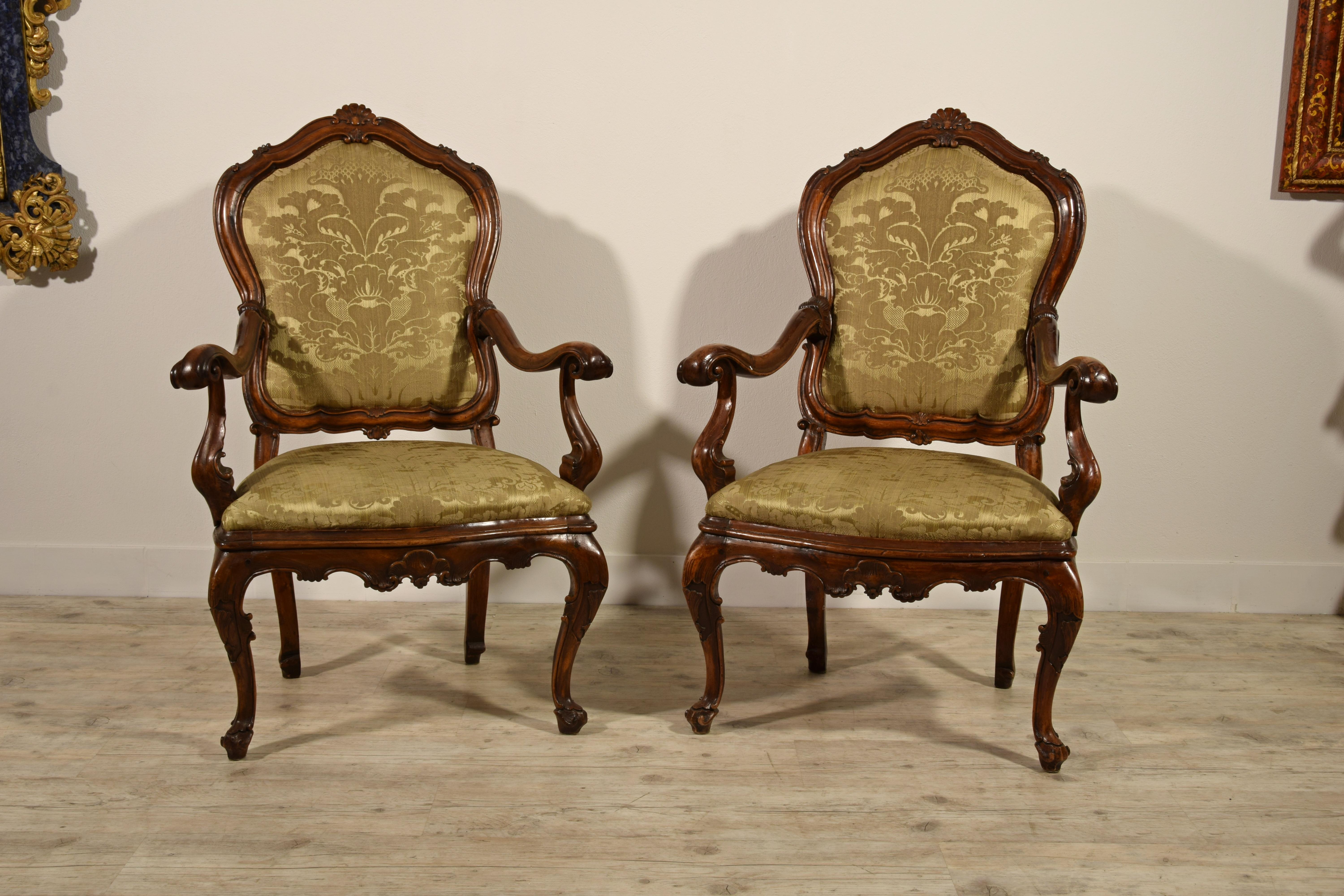 18th century, pair of Italian Louis XV wood armchairs.

The delightful pair of armchairs is made in Italy (Venice) in the first half of the 18th century. They are of solid walnut wood, finely carved with rocaille motifs characteristic of the Louis