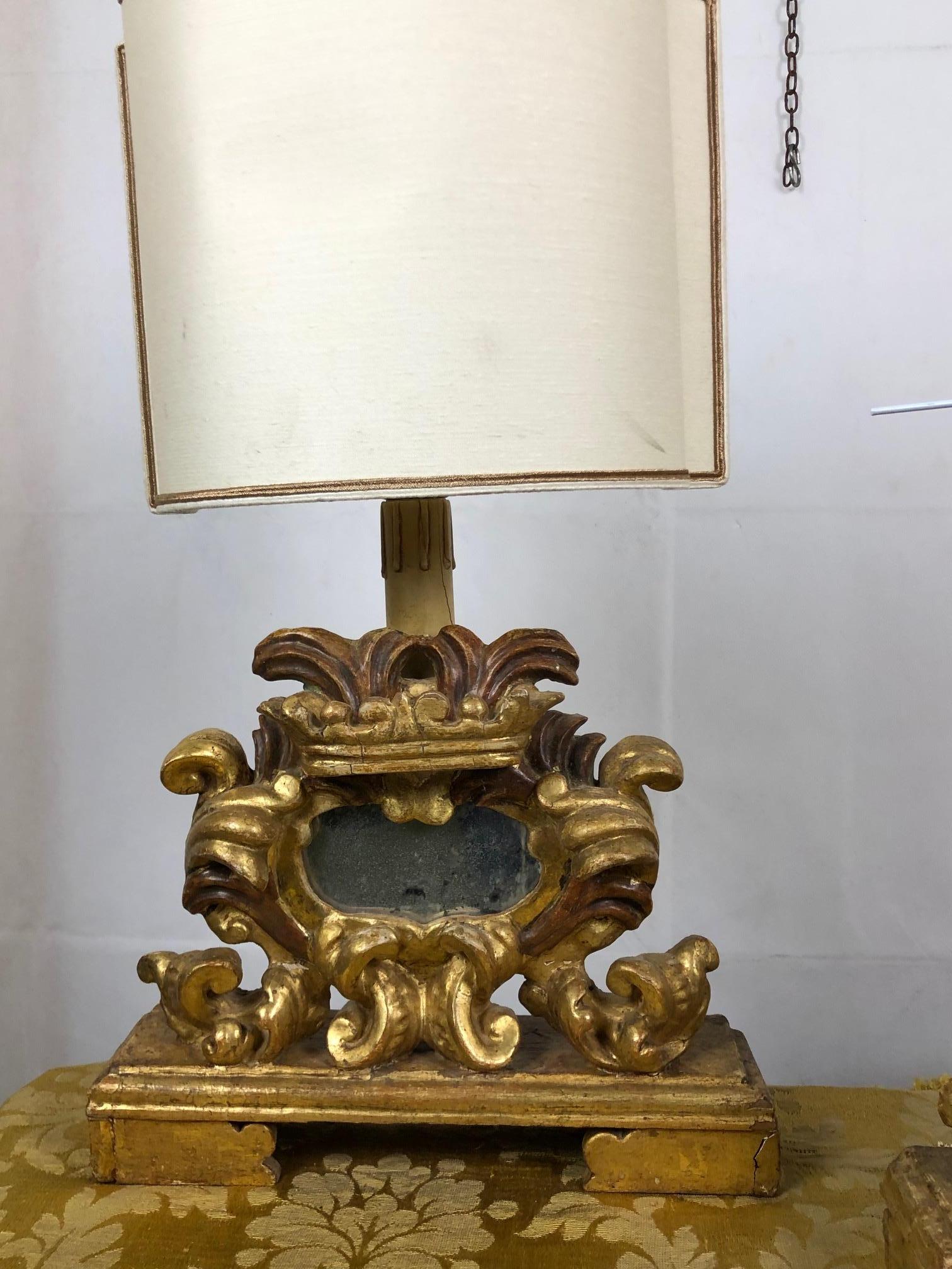 Splendid and original Venetian relics in gilded wood adapted to lamps.