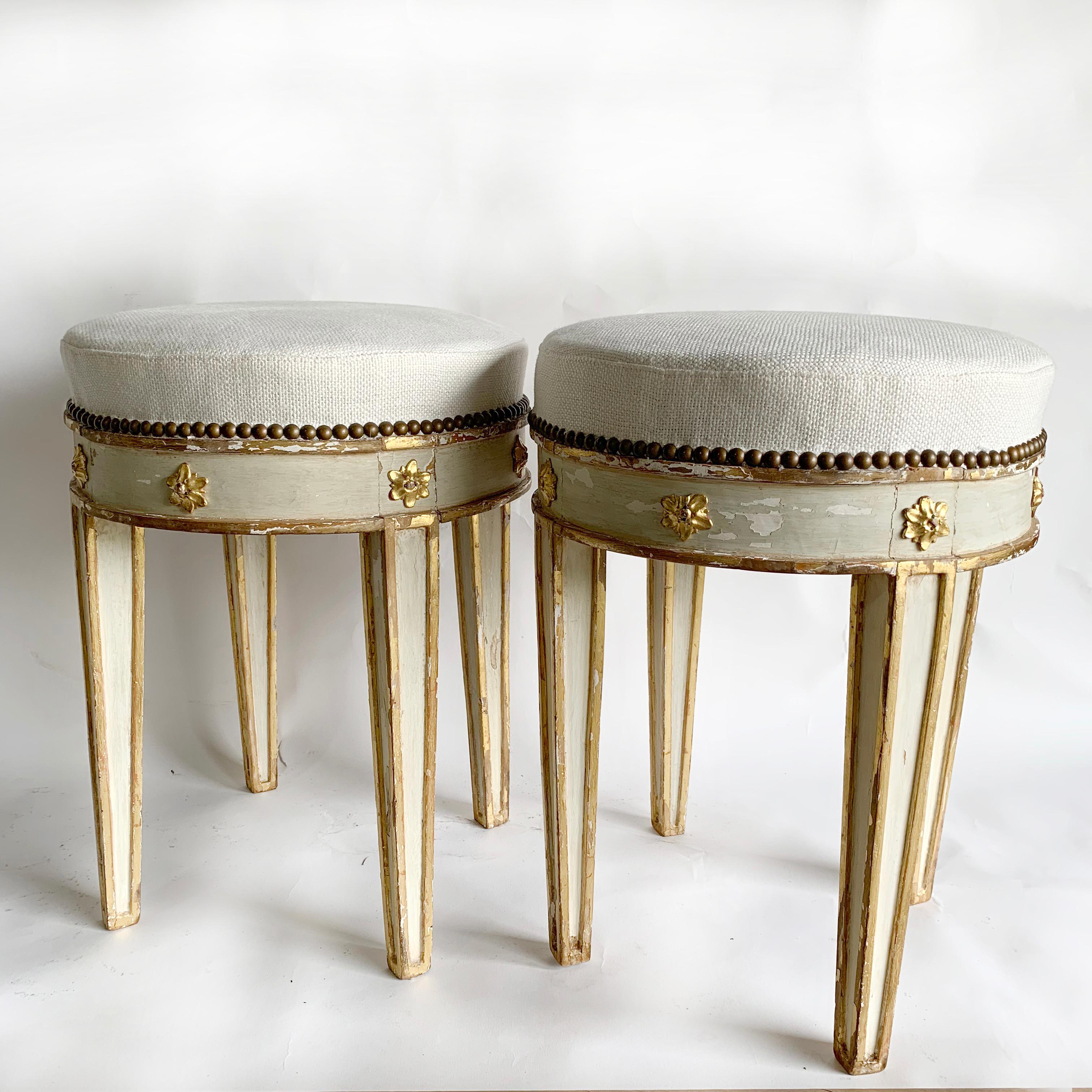 Beautiful 18th century pair of Swedish tabouret stools with rare gilt neoclassical carvings. New upholstery in a heavyweight white Belgian Linen.