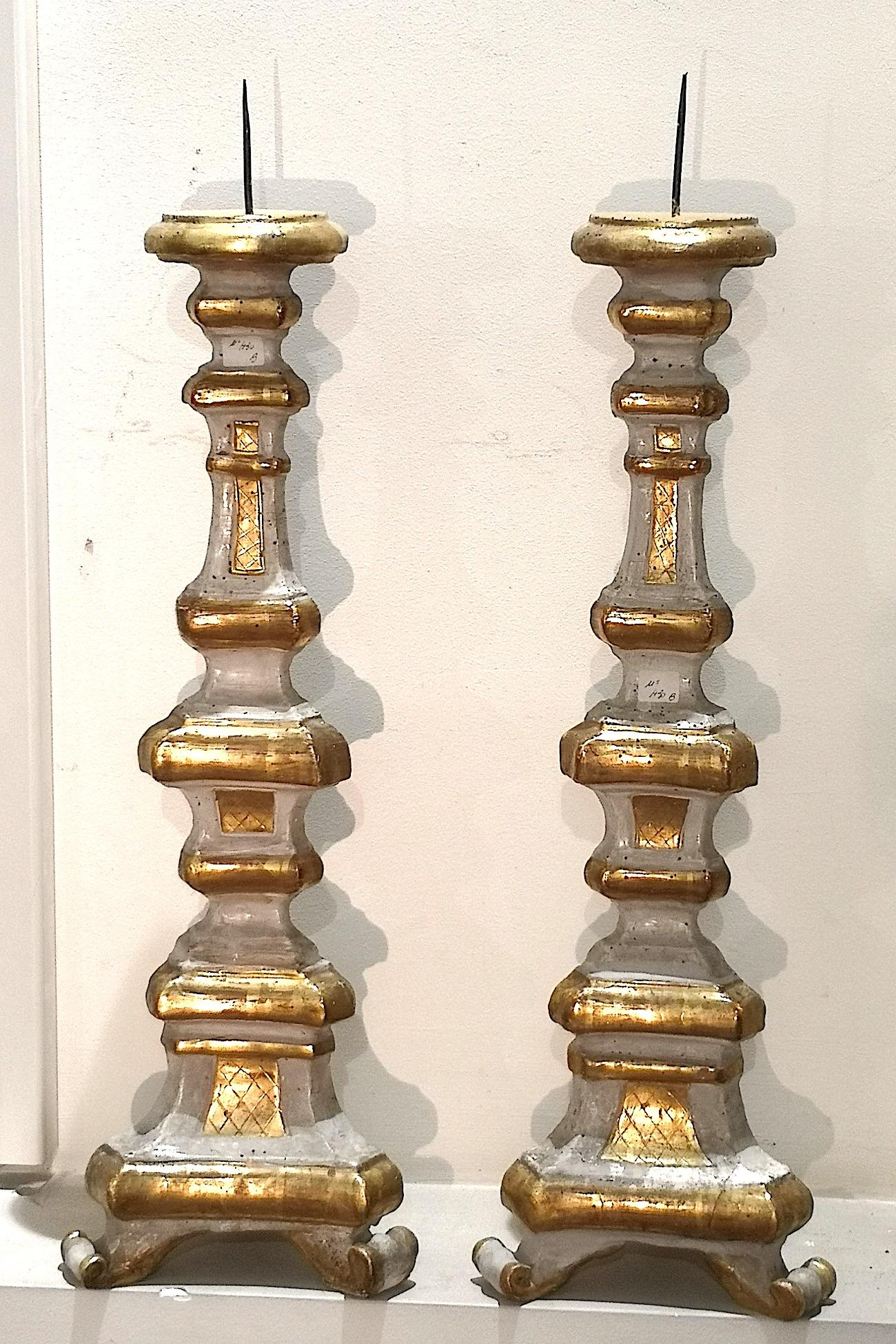 A wonderful pair of small Venetian parcel gilt and paired torchères or candle holders from the middle to the end of the 18th century. Each torchère measures 26 inches high. The base is 8.5 inches wide and 7.5 inches deep. The use of these objects