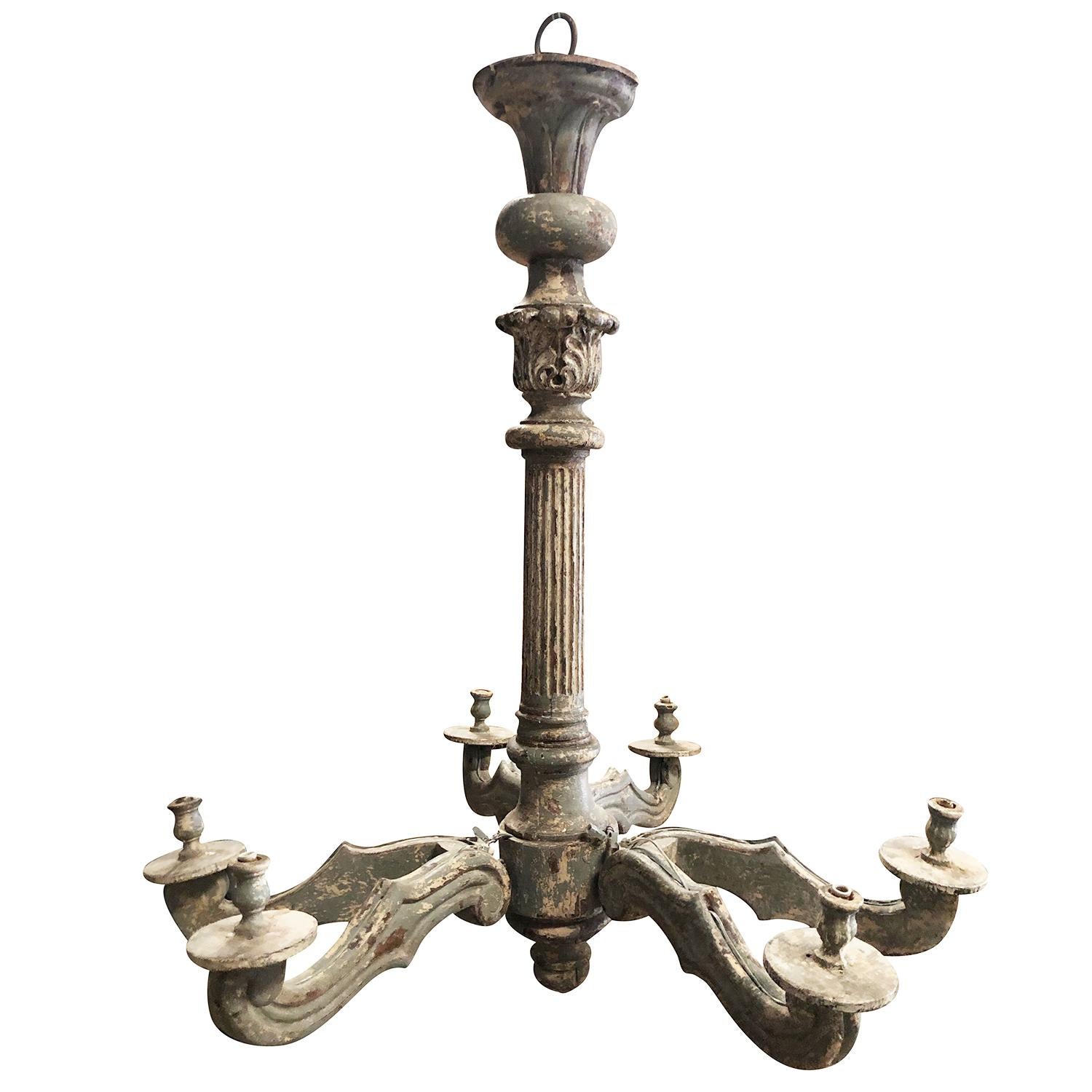 An antique pair of late 18th century wooden carved chandeliers composed of six arms leaf decorated with original gilt, in good condition. The Italian light fixtures are electrified to European standard and could be adapted. Minor fading, due to age.