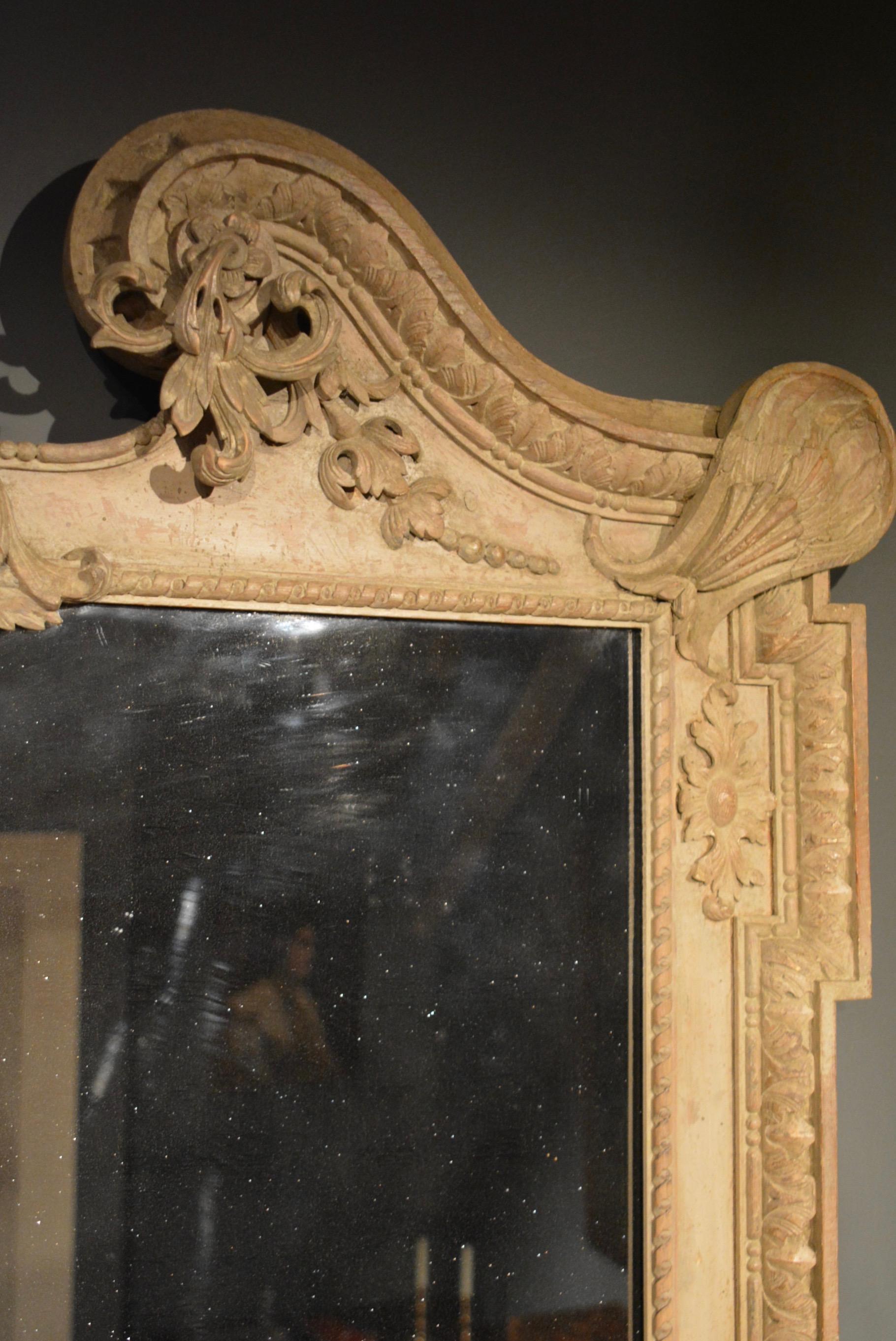 A George II large carved pine mirror retaining it's original two tone paintwork decoration of very soft green and very soft blue, the shell corners bear similarities to a drawing held by the Victoria & Albert Museum in London which is attributed to