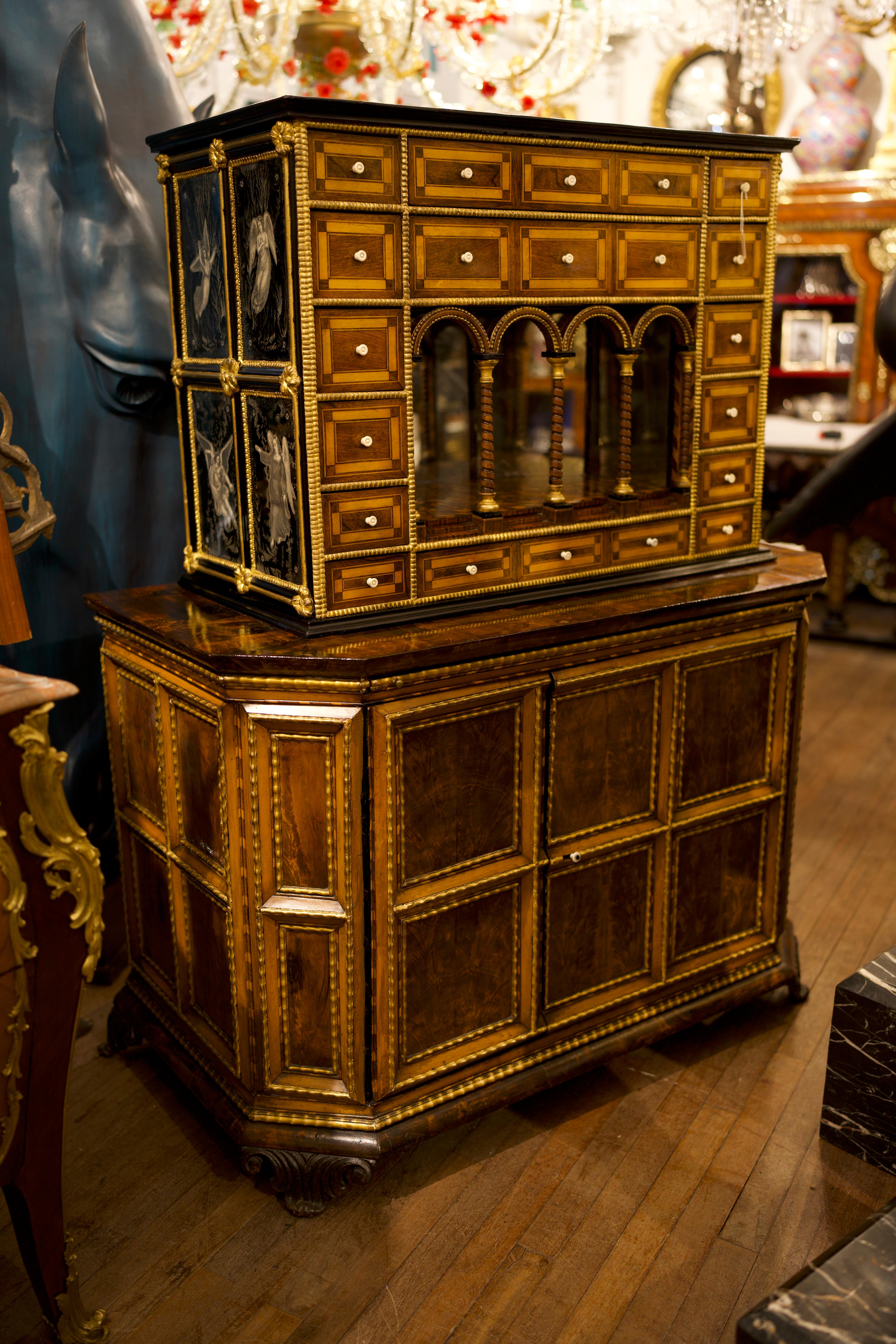A stunning 18th Century Parquetry Flemish cabinet and base.

The furniture veneered in various woods and brambles of walnut, maple, rosewood and gilded wood decorations. The Upper part with small drawers and castle with twisted columns and mirror.