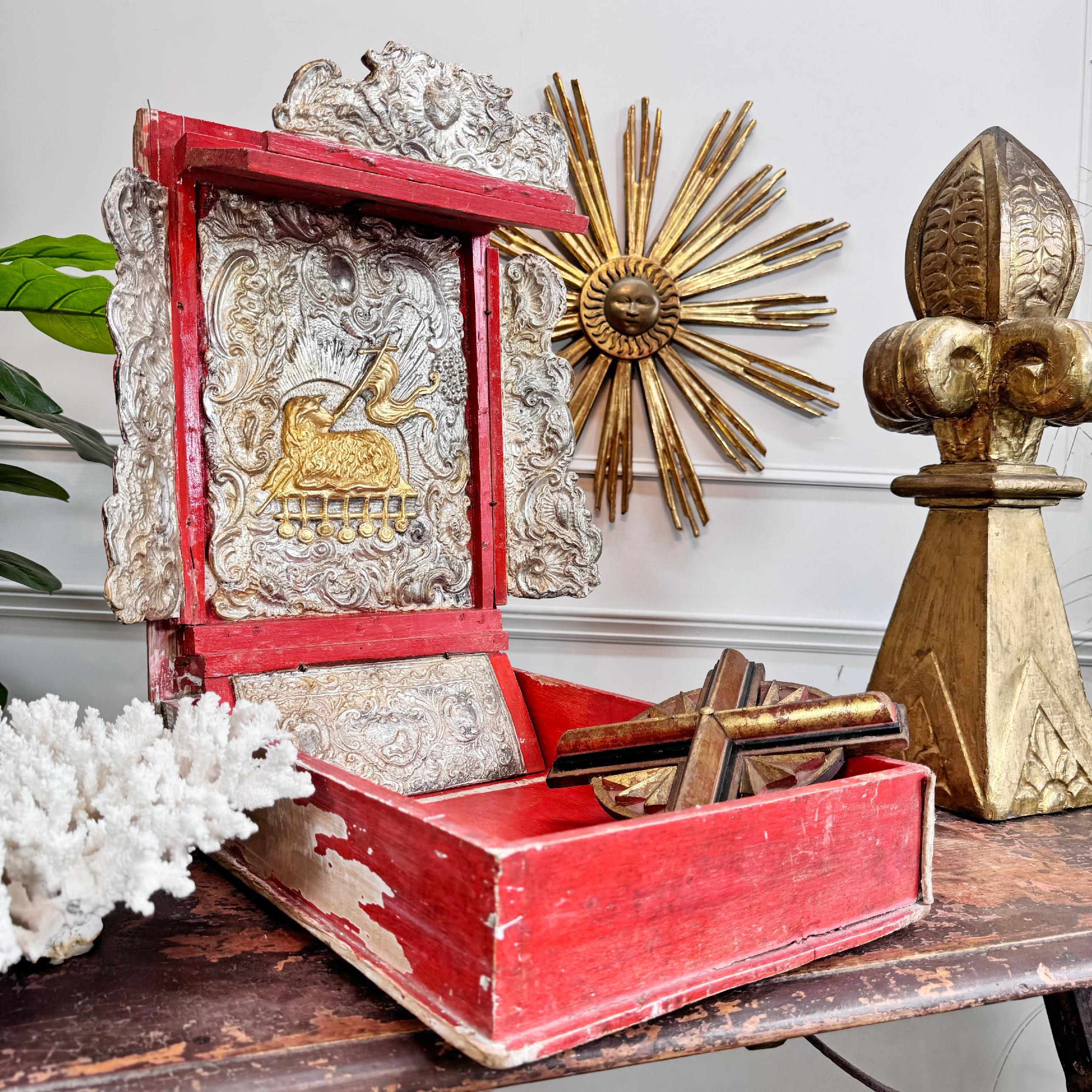 This truly exceptional 18th century bible box, formed as a book and profusely decorated in pastiglia throughout, in silver and gold gilt, at it's centre the gilt Lamb of God, the pine body stained in a time worn crimson. The quality of this piece is