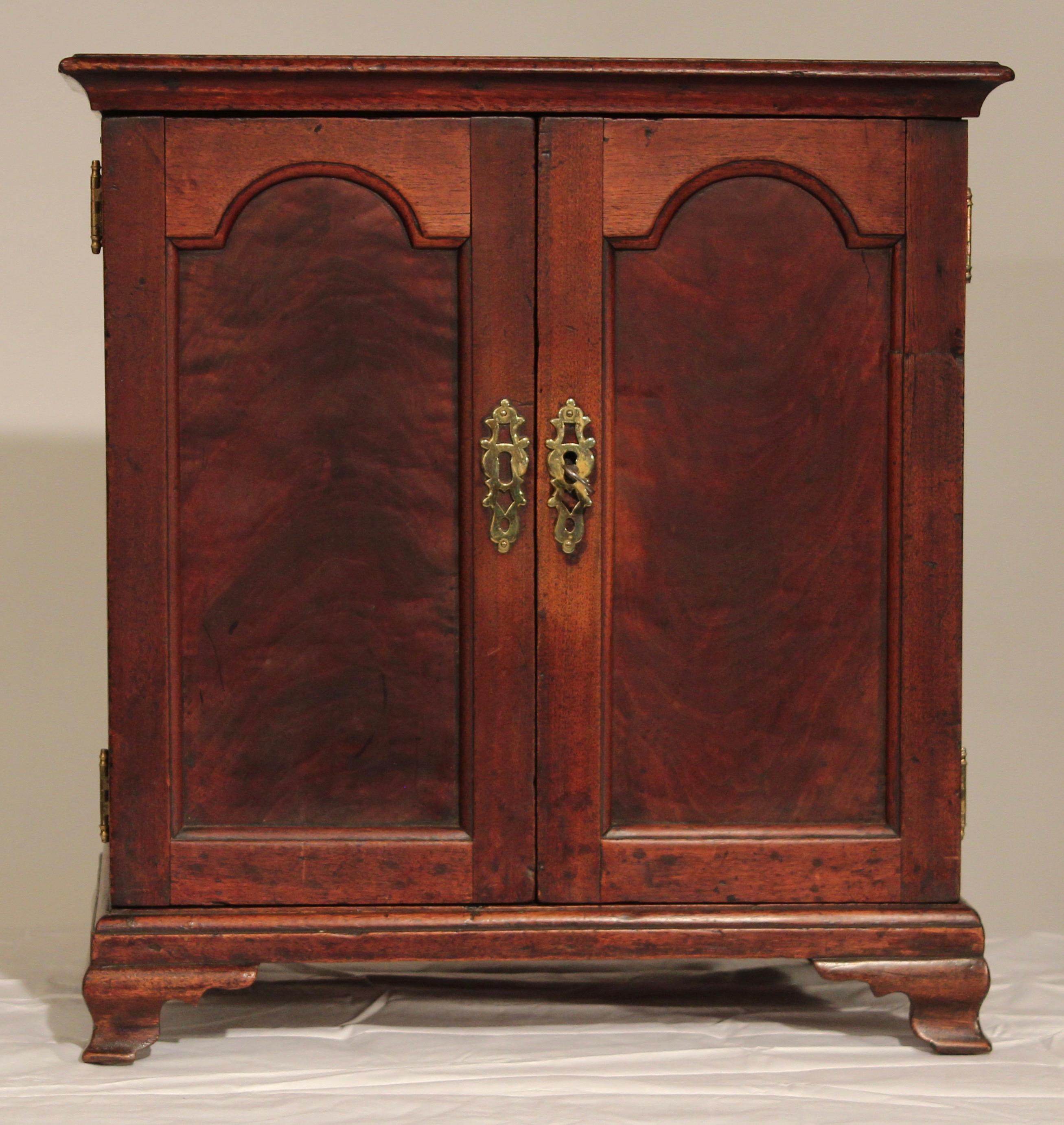 Wonderful rare Pennsylvania Chippendale double door spice box with arched flat panels on the doors very nice old patina and terminating in Ogee feet.