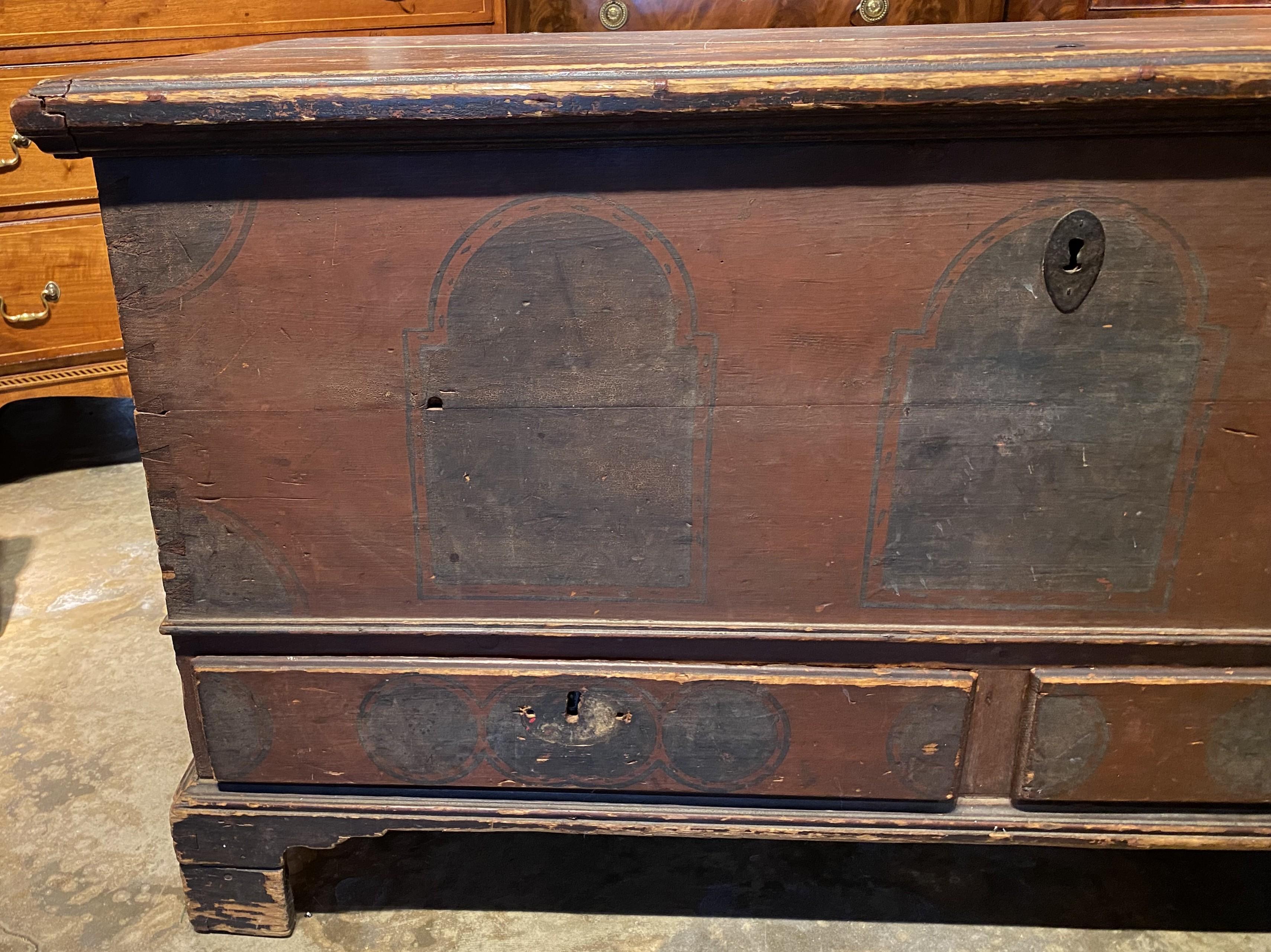 A Pennsylvania pine painted two drawer dowry or blanket chest with a wonderful surface. The chest with strap hinges, an interior till with two small drawers, accented with circular and arched hand painted decoration, all supported on four carved