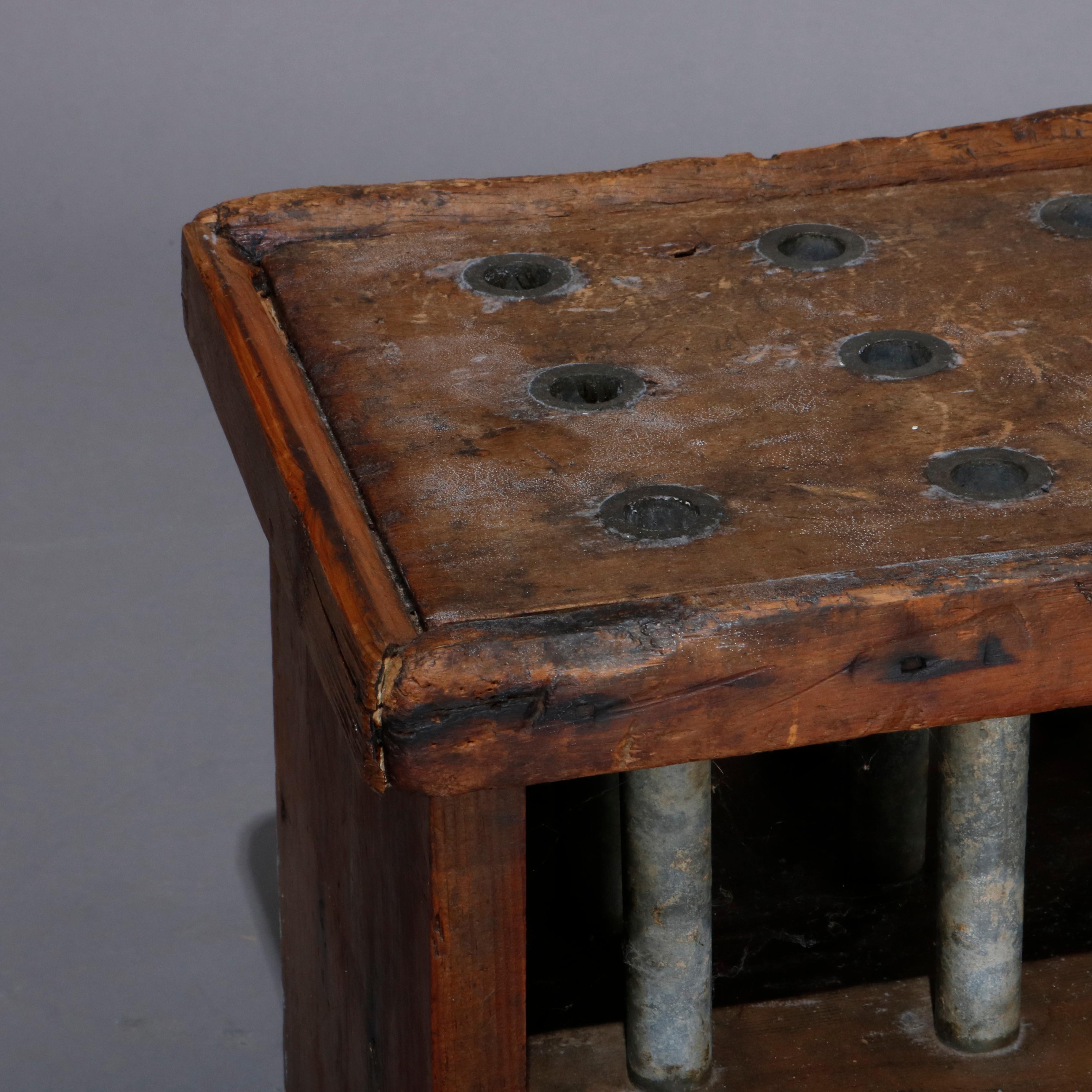 An antique Colonial candle mold of the period offers wooden frame with 21 tin candle molds, 18th century.

Measures: 16