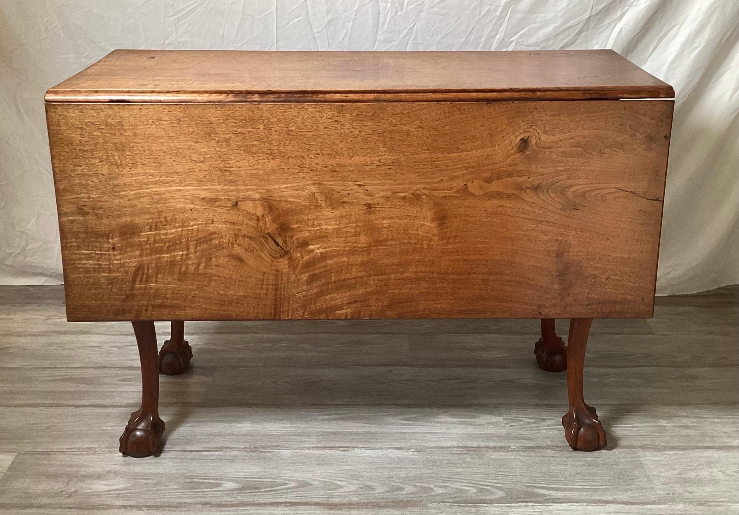 Elegant 18th century walnut drop leaf dining table.  The table with ball and claw feet, in a solid warm light walnut with 2 leaves which makes the top measure 42 deep by 49.5 wide.  