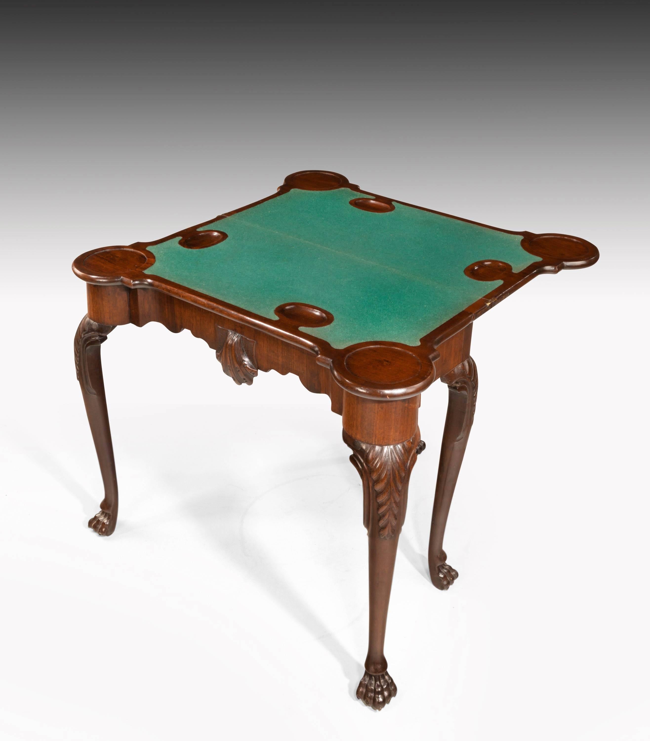 A particularly good late 18th century Irish mahogany card table. The interior with guinea wells. Well carved cabriole supports terminating in claw feet. 

T

 