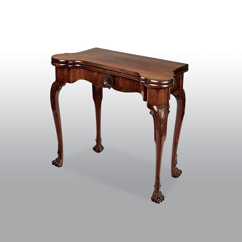 A fine 18th century Irish mahogany tea table with exceptional colour and patination, with carved acanthus leaves on knees and carved scalloped shell on frieze. The bold cabriole supports terminating in claw feet.