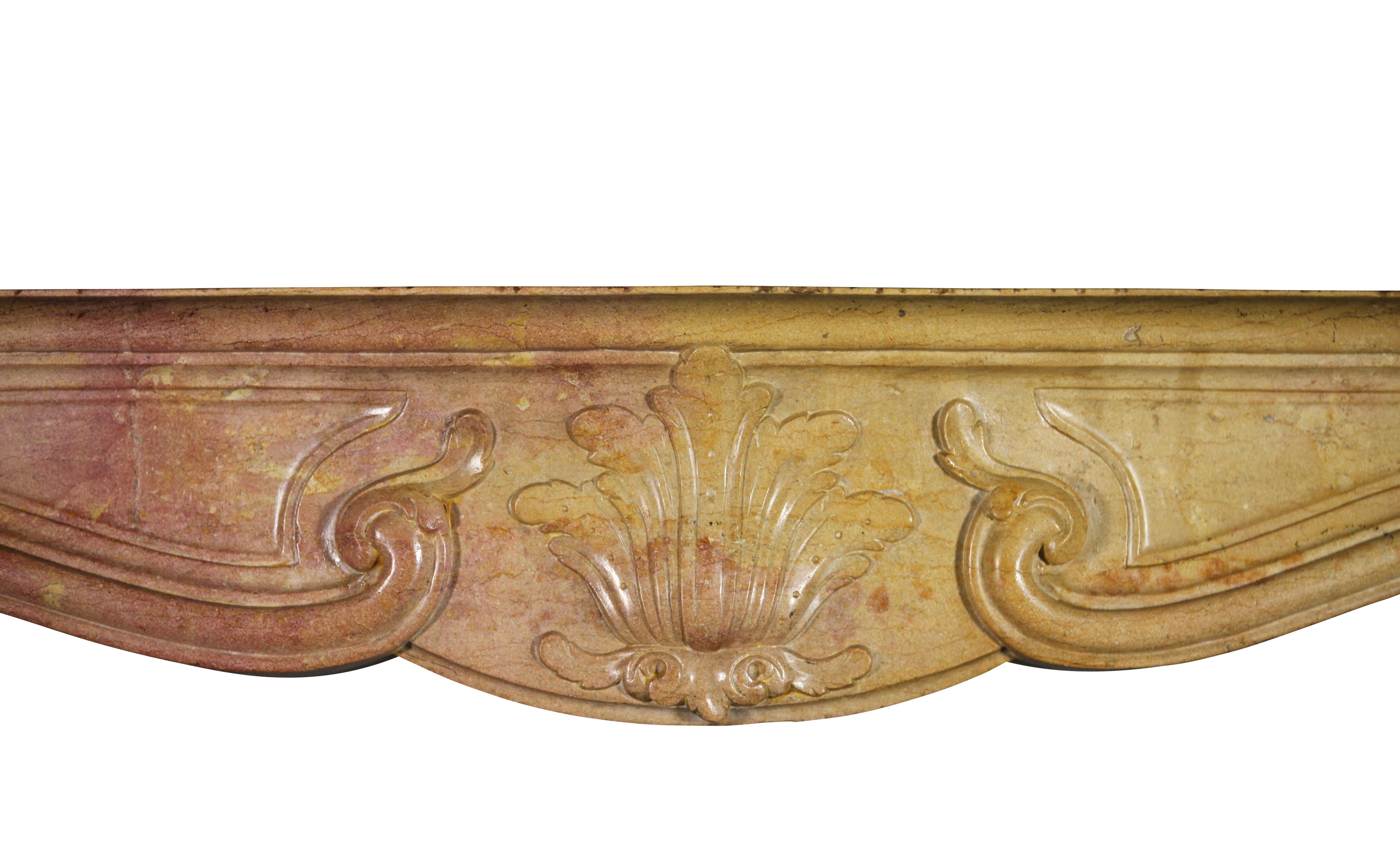 This is a unique, one of a kind, bicolor French Burgundy marble hard stone original antique fireplace mantle. The size being petite makes this a small and charming mantle piece suitable for many small rooms and interior designs. The carving is very