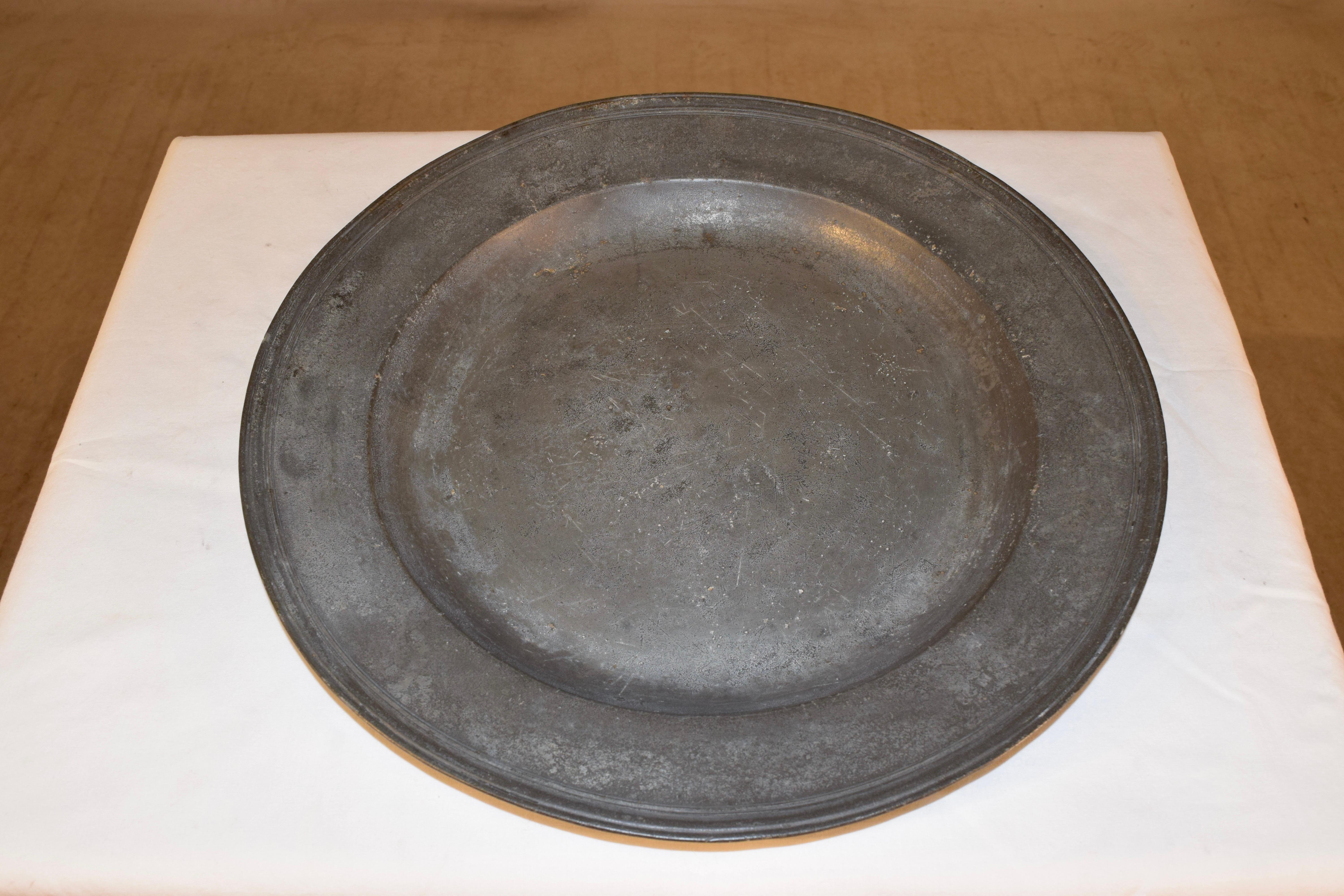 18th century pewter charger from England with London marks on the back of the rim, which is pictured. Gorgeous patina.