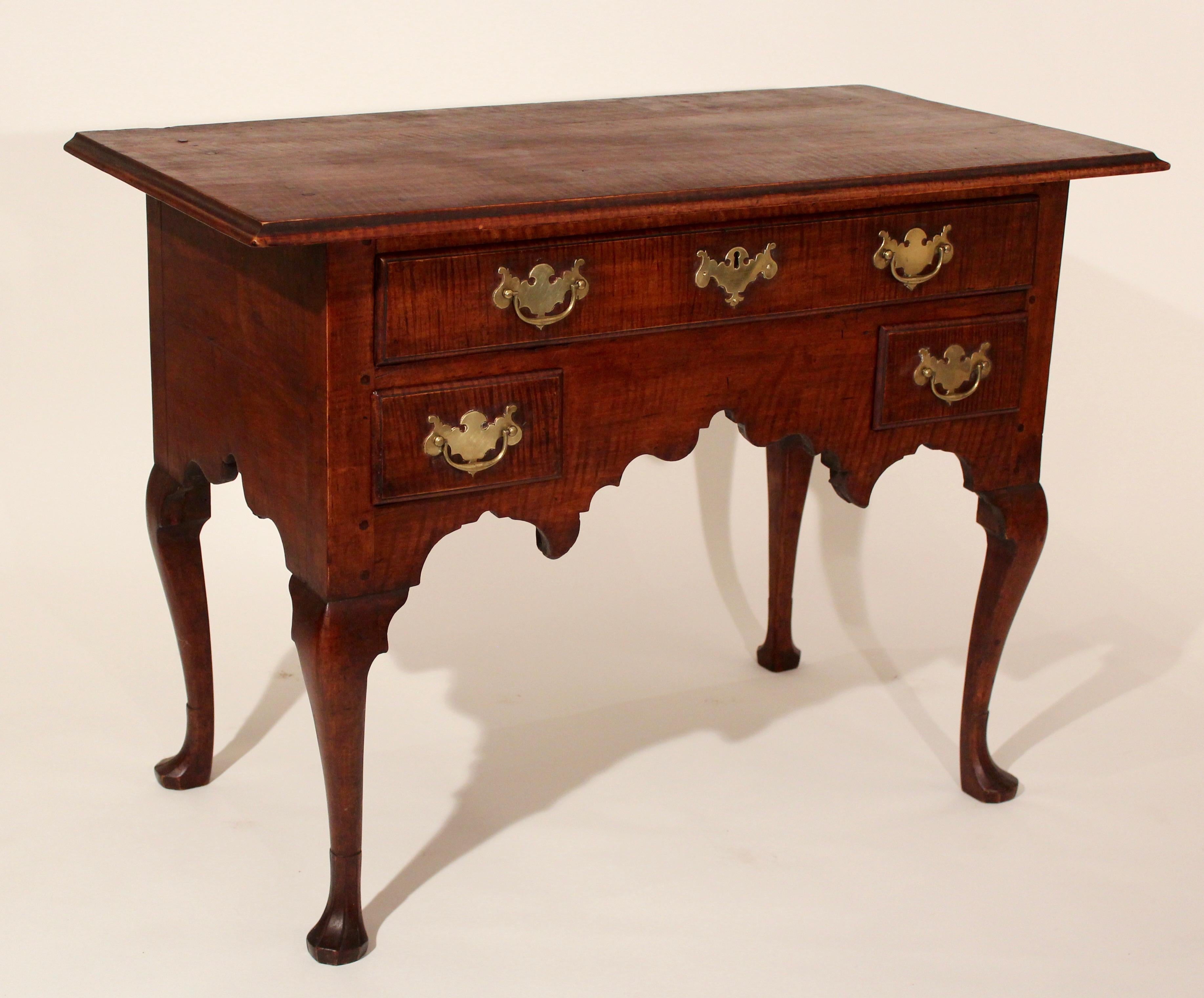 18th century Philadelphia tiger maple Queen Anne dressing table with nicely scalloped base one drawer over two configuration still retaining its original plate brasses, Cabriole legs terminating in faceted foot.