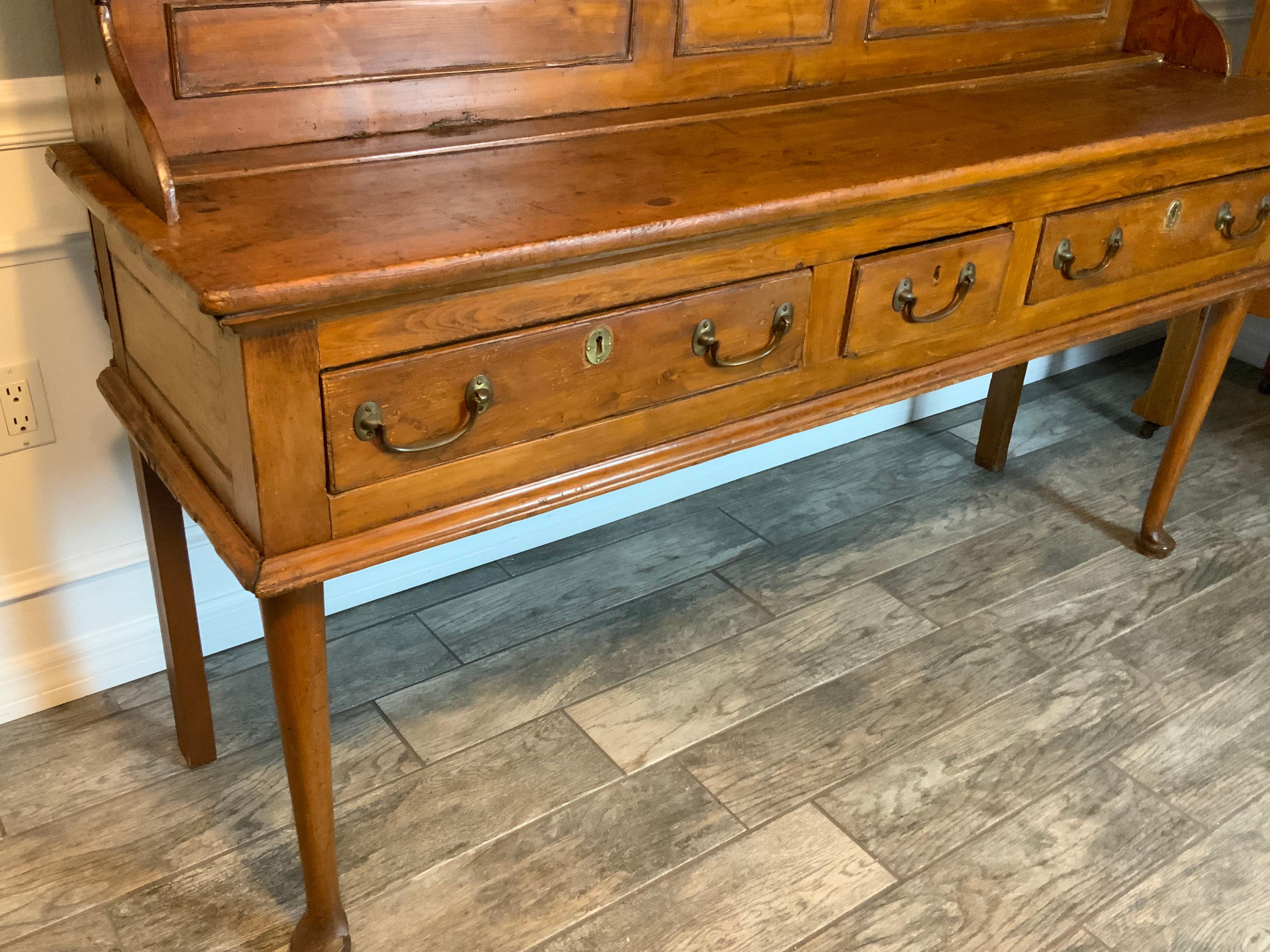  Very attractive two piece mid 18th century Pine Welsh Dresser.  Could very well be Colonial New England made 1740-50.  Original hardware and drawer locks intact.   Very good condition with an excellent color and aged patina to the old refinish. 