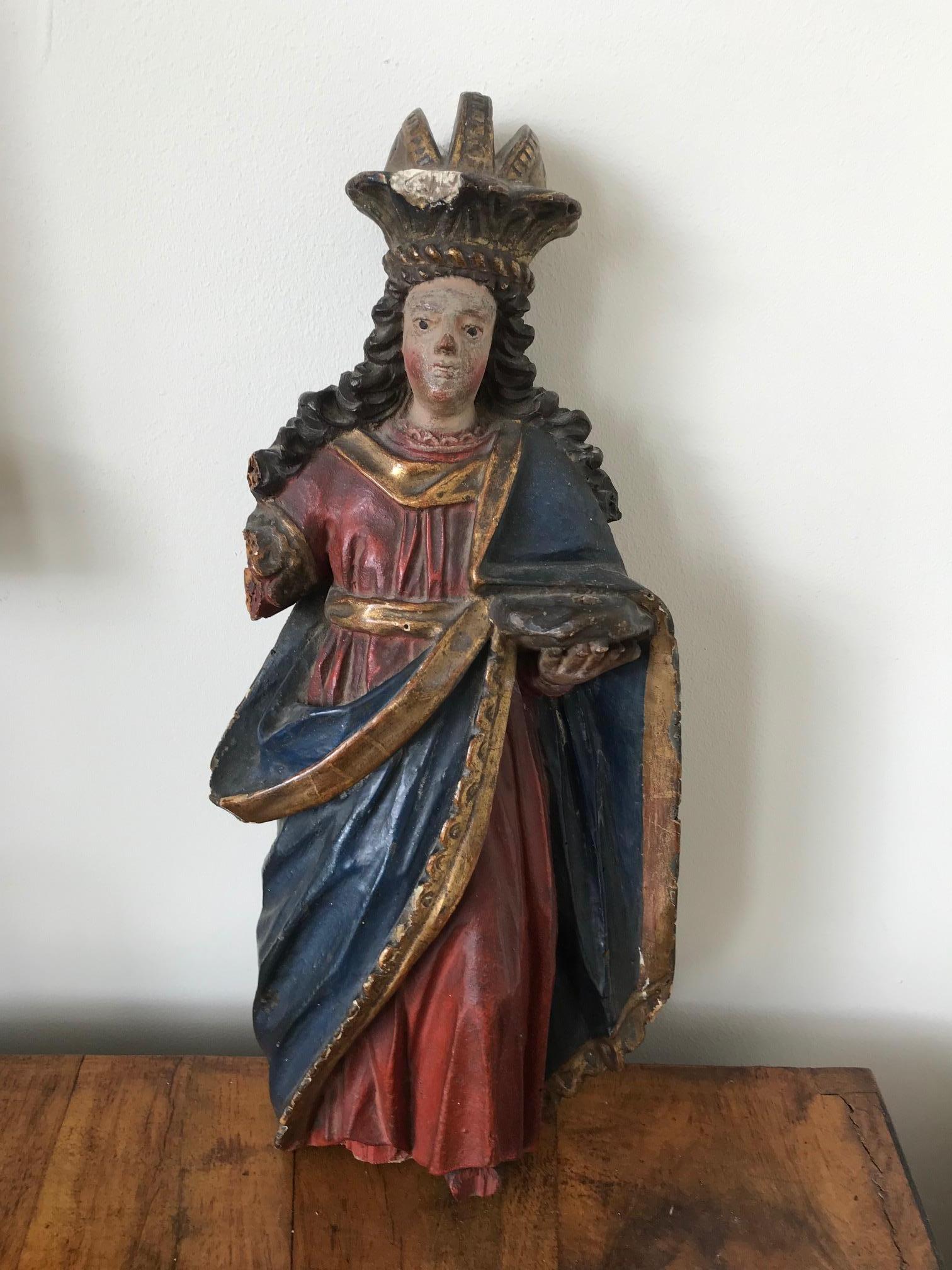A wonderful possibly Italian early 18th century Baroque polychrome statue of a crowned saint. Wonderful naive carving with remnants of good color and gilding. Some obvious damage and losses which should be visible in the photos. Would most likely