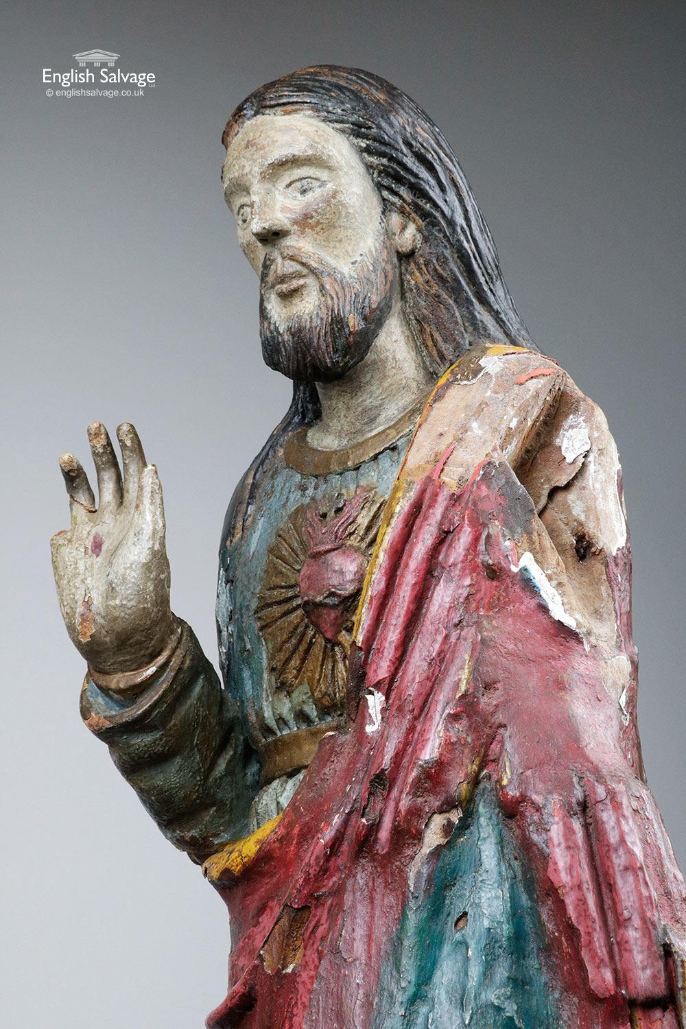 Antique hand carved wooden polychrome Sacred Heart Jesus figure, dating from circa 17th-18th century. Some loss to the back of the base, the right shoulder, the left hand side of the face plus one finger is missing and another needs reattaching.