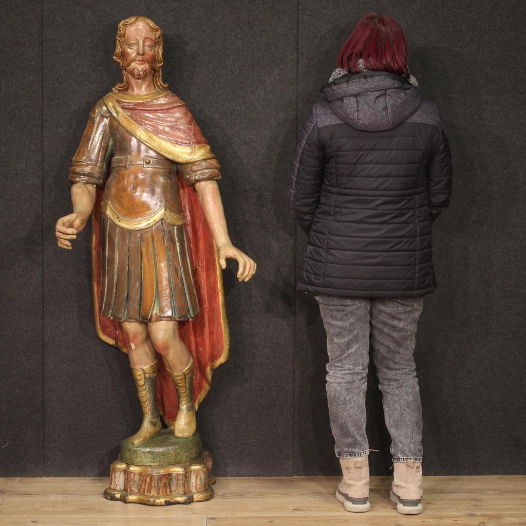 Great Italian sculpture from the second half of the 18th century. Finished wooden work from the center depicting an almost life-size Roman soldier. Statue complete with lacquered and gilded wooden base which raises it by 13 cm. Sculpture lacking