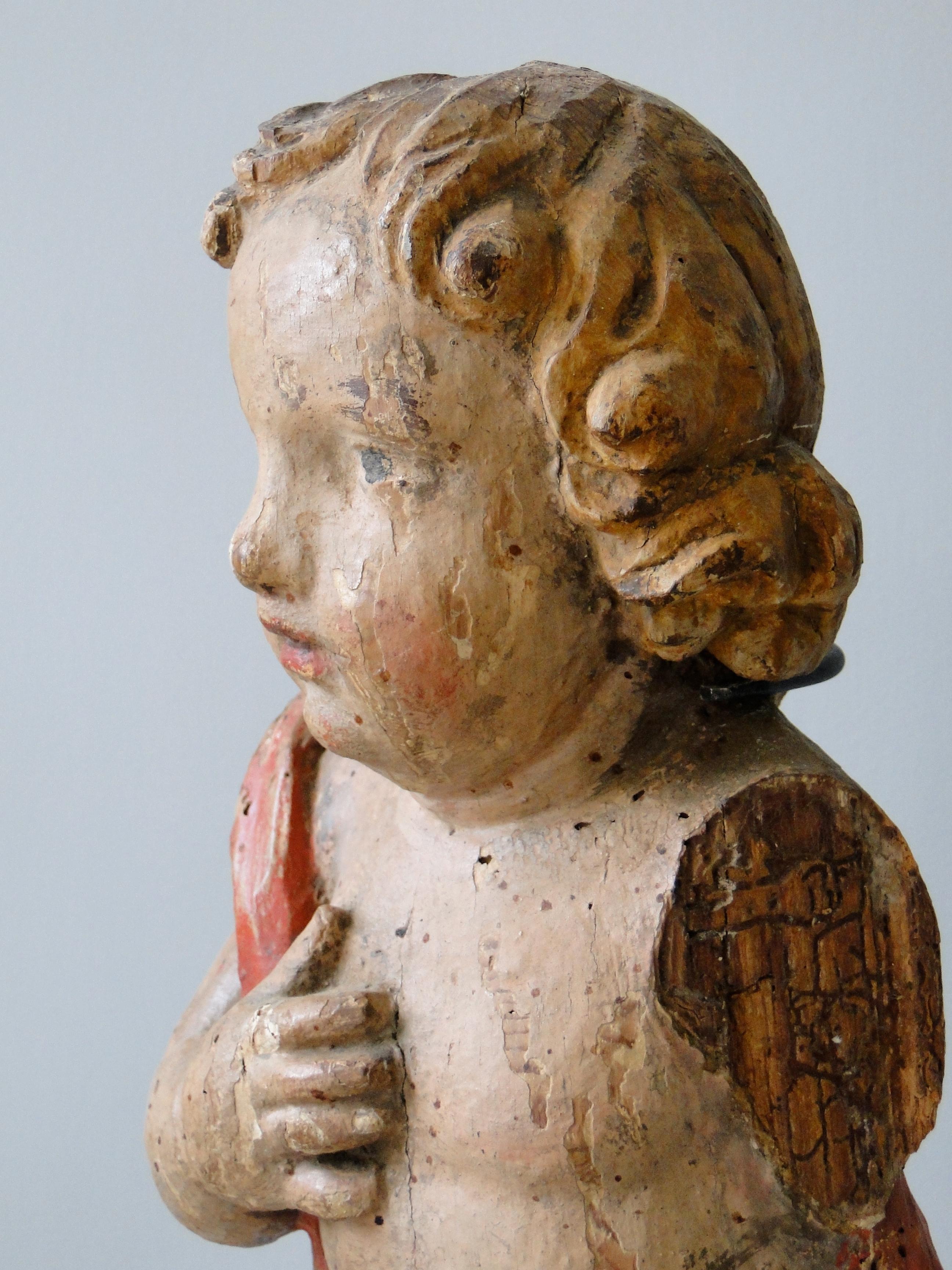 18th century Baroque angel on iron base from Germany, polychromed wood. One arm and a toe are missing.
