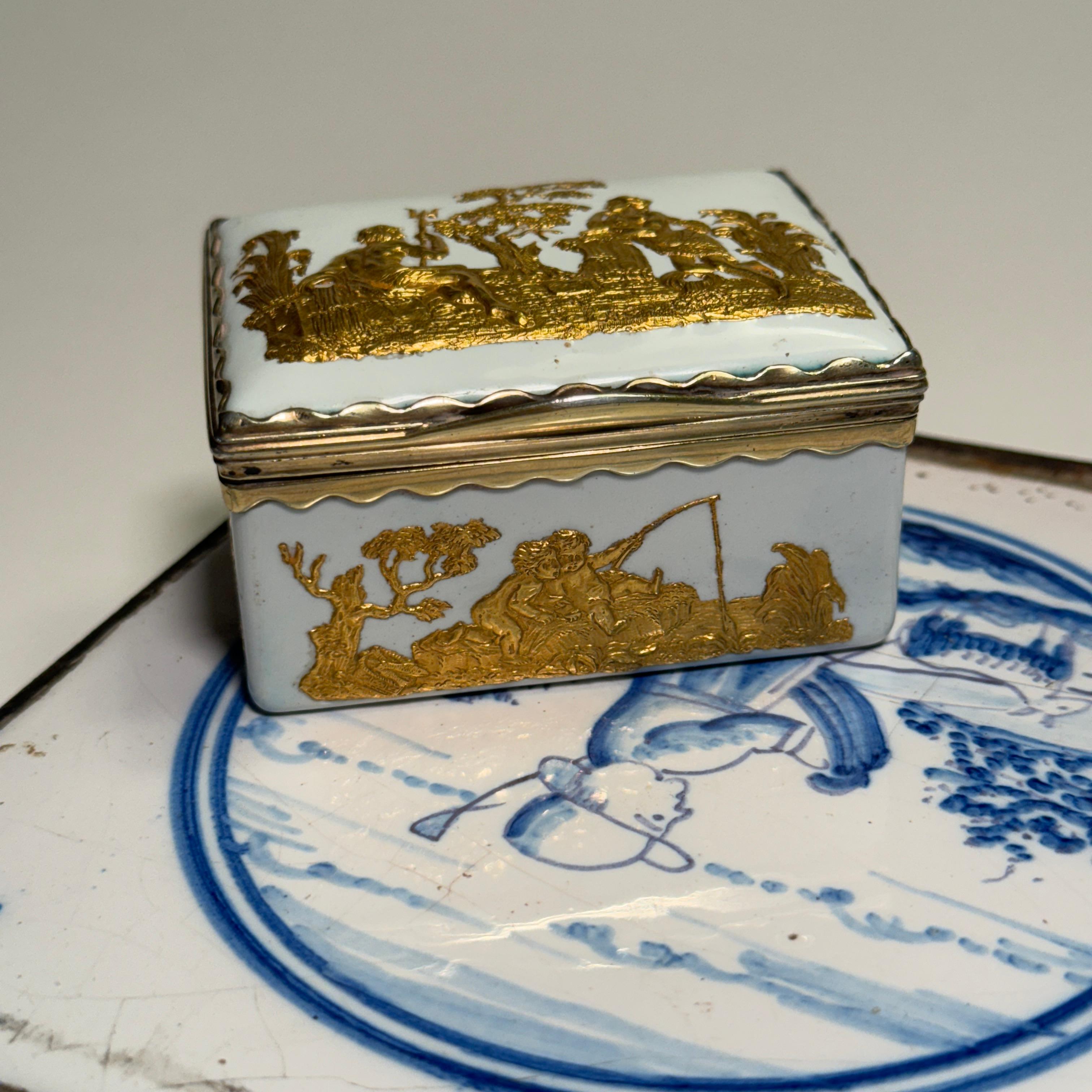 Mid-18th Century porcelain snuff tobacco box with Ormulu gilt embossed relief and with empire classical motives. The inside of the lid is decorated with colorful flowers.
Wonderful addition to any collection on a tabletop or shelves. This classic