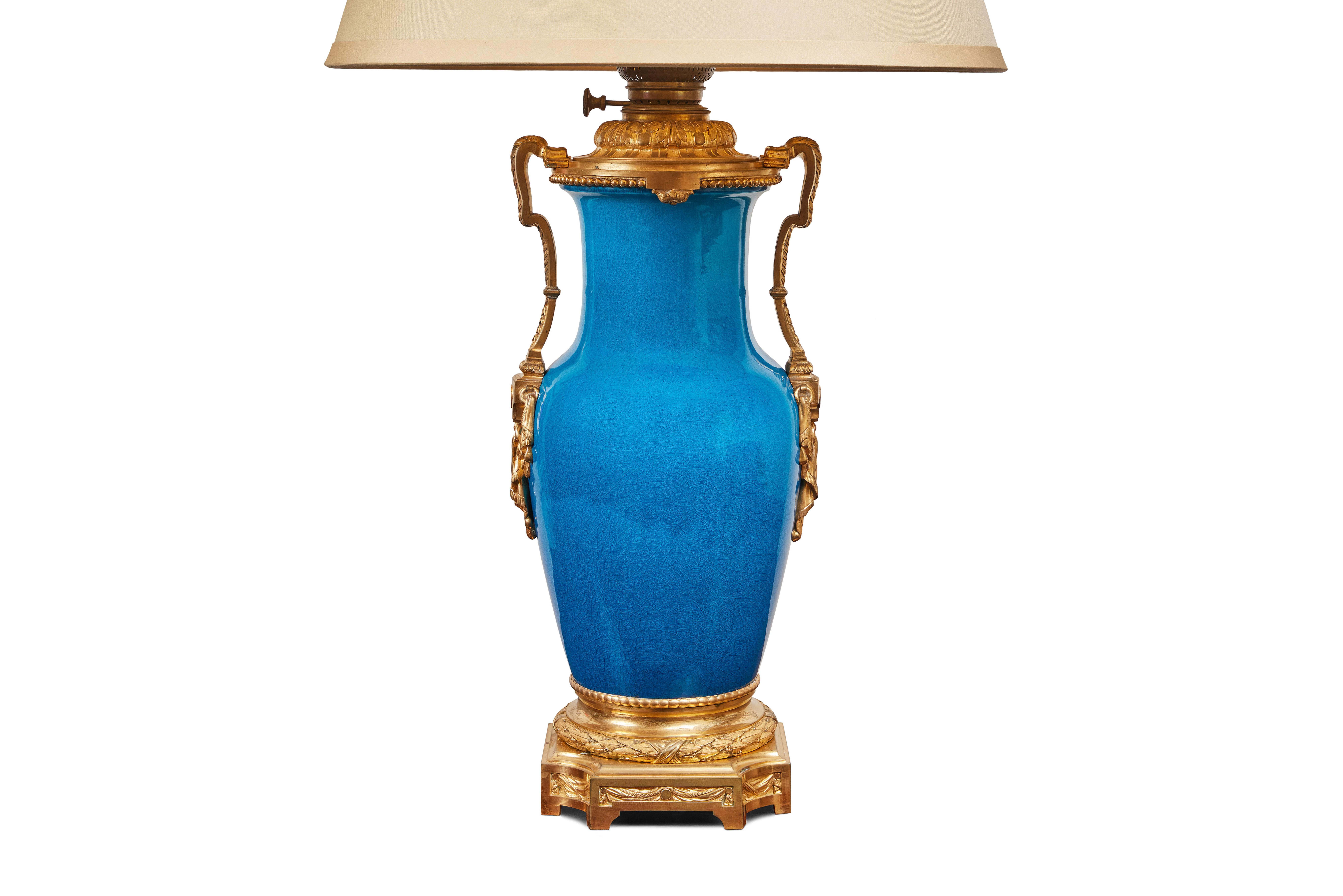A vibrant, hand painted and glazed, Louis XIV style, French porcelain vase with brilliant, gilt bronze mounts. During the 19th c. the piece was made into a gas lamp but is now wired for U.S. current. Note, the height of the lamp is adjustable.