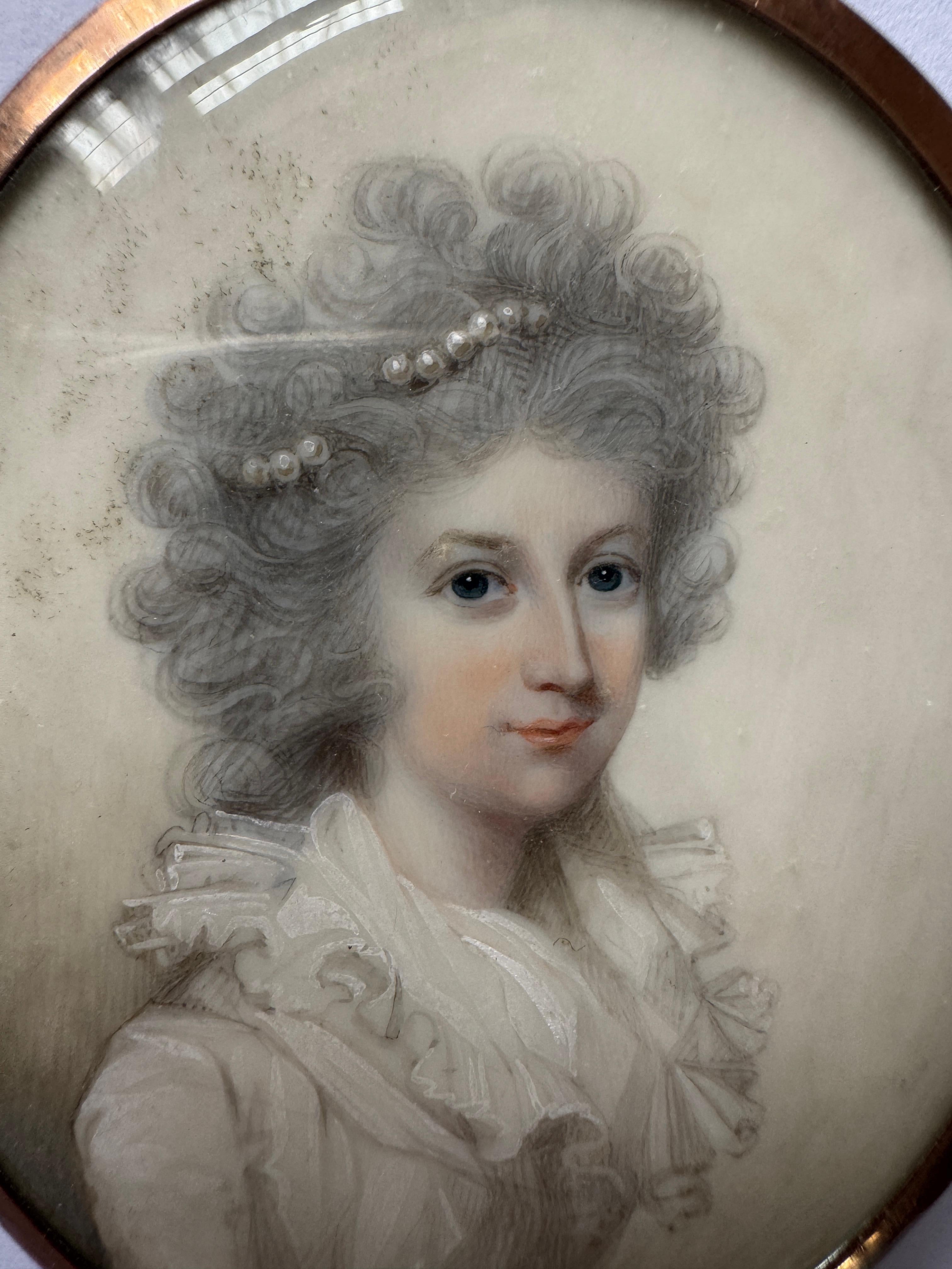 18th Century Portrait Miniature Attributed to George Engleheart (1750 - 1829) , Portrait of a young lady, bust length, her powdered hair adorned with pearls and wearing a white dress with a ruffled collar watercolour. Oval 6.5cm / 2.5