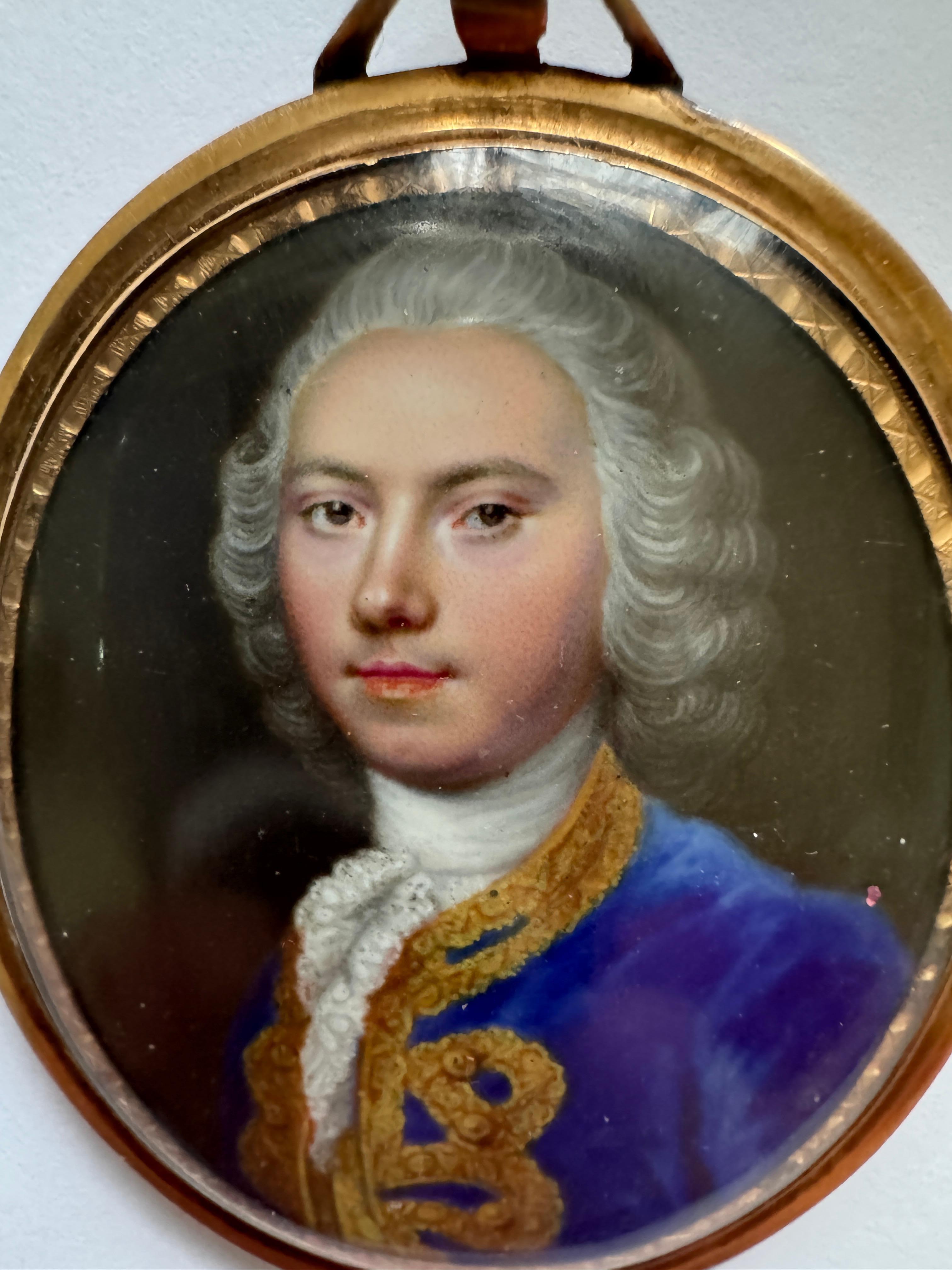 18th Century Portrait Miniature Attributed to Jean Etienne Liotard (1702 -1789) , Portrait of a young man, bust length, with powdered hair and wearing a blue velvet coat embroidered with gold facings. Enamel size 4.5 x 4 cm. In a gold frame with