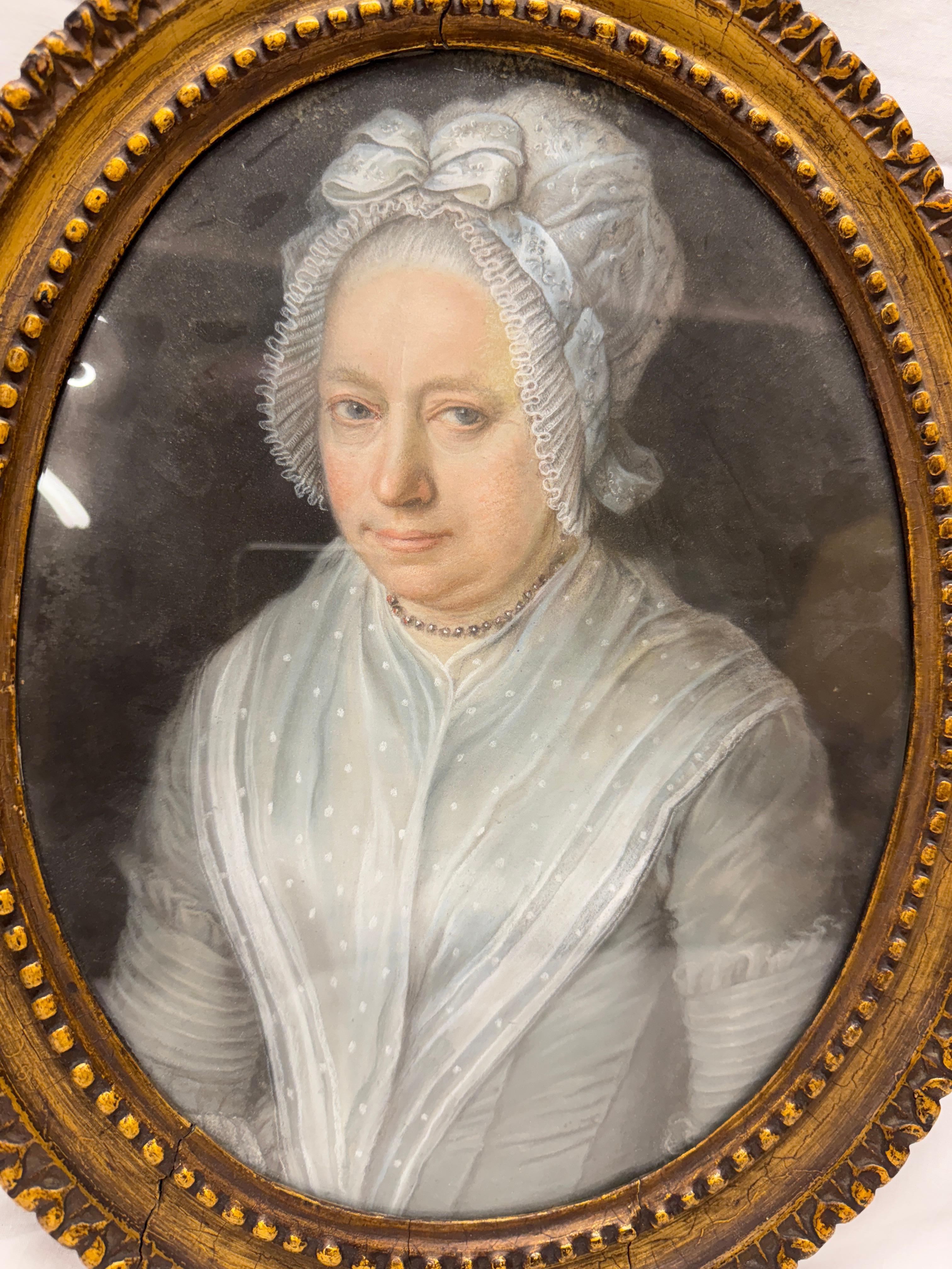 Portrait d'une dame du XVIIIe siècle, encadré dans un cadre ovale en or délavé. Portrait tête et épaules d'une dame en robe bleue et bonnet. Pastel sur papier.

Taille du cadre 14.5