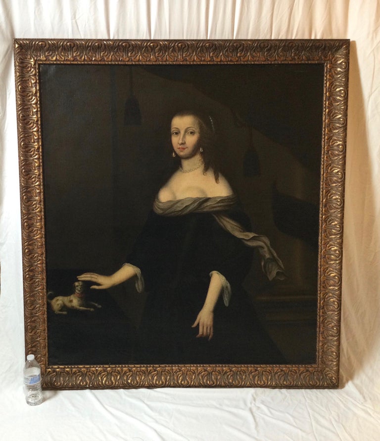 Elegant and large portrait of an aristocratic lady in a later giltwood frame. The painting has been lightly cleaned and restreached with a label on the back suggesting this to be the woodgate family from Kent England . Unframed, 47.5 h, 43 w, framed