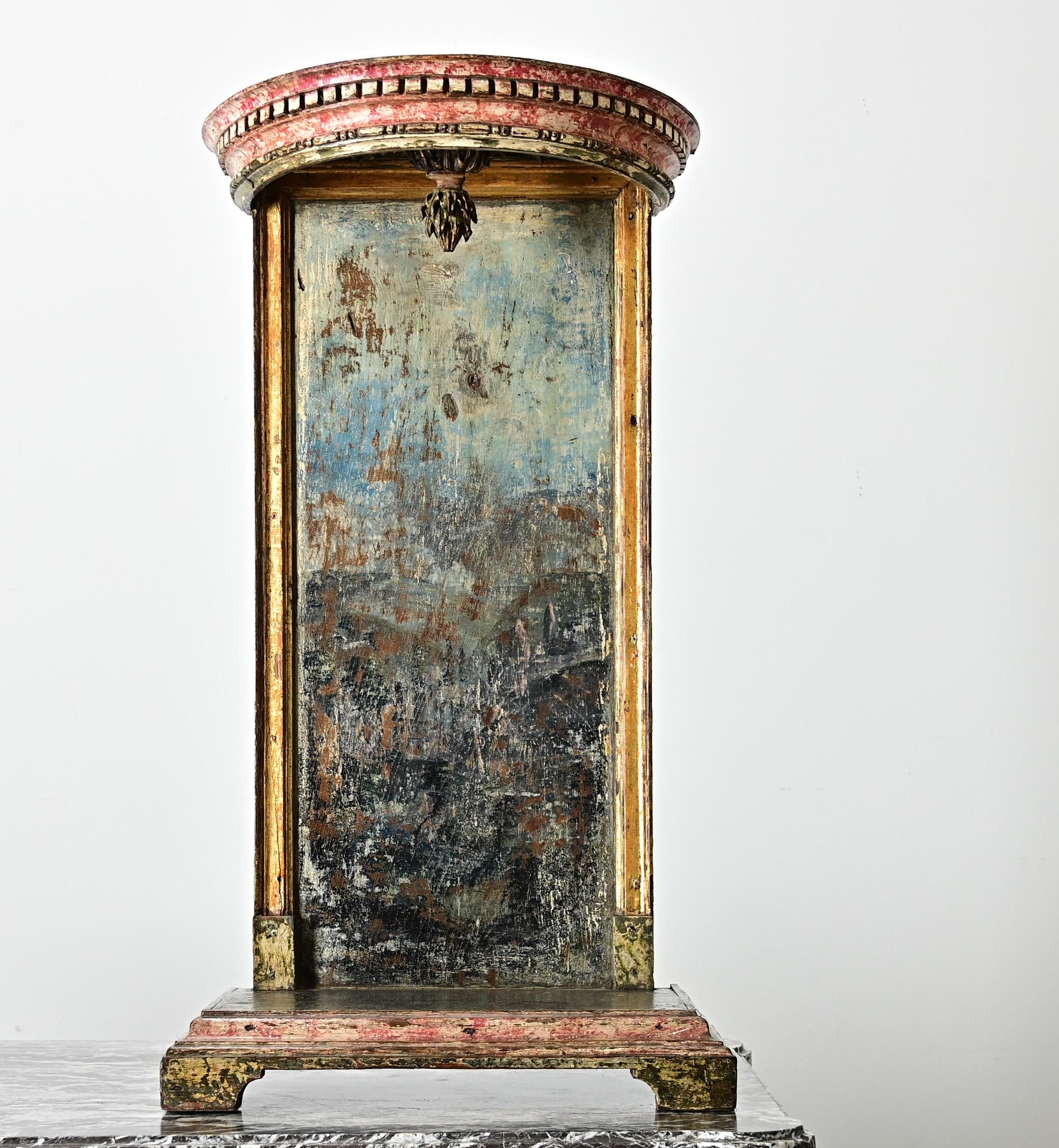 An exquisite work of 18th century Portuguese craftsmanship, this carved, painted, and gilded wood tabletop altar-niche would have been used to stage religious artifacts or statuary for display. Suspended from the red demilune crown is a