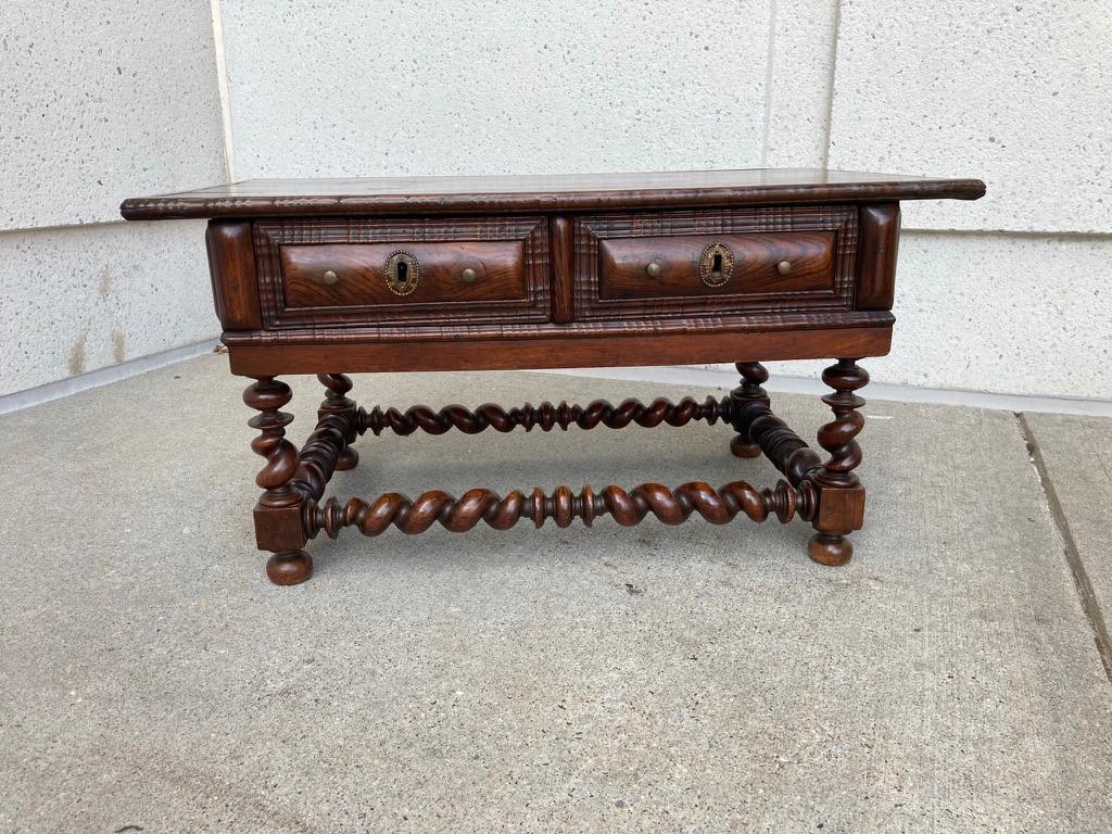 A late 18th or early 19th century Portuguese two drawer rosewood table with spirally-turned legs and stretchers. The construction of this table is all original, with dovetail joints and hand wrought rose head nails. Likely 18th century, though the