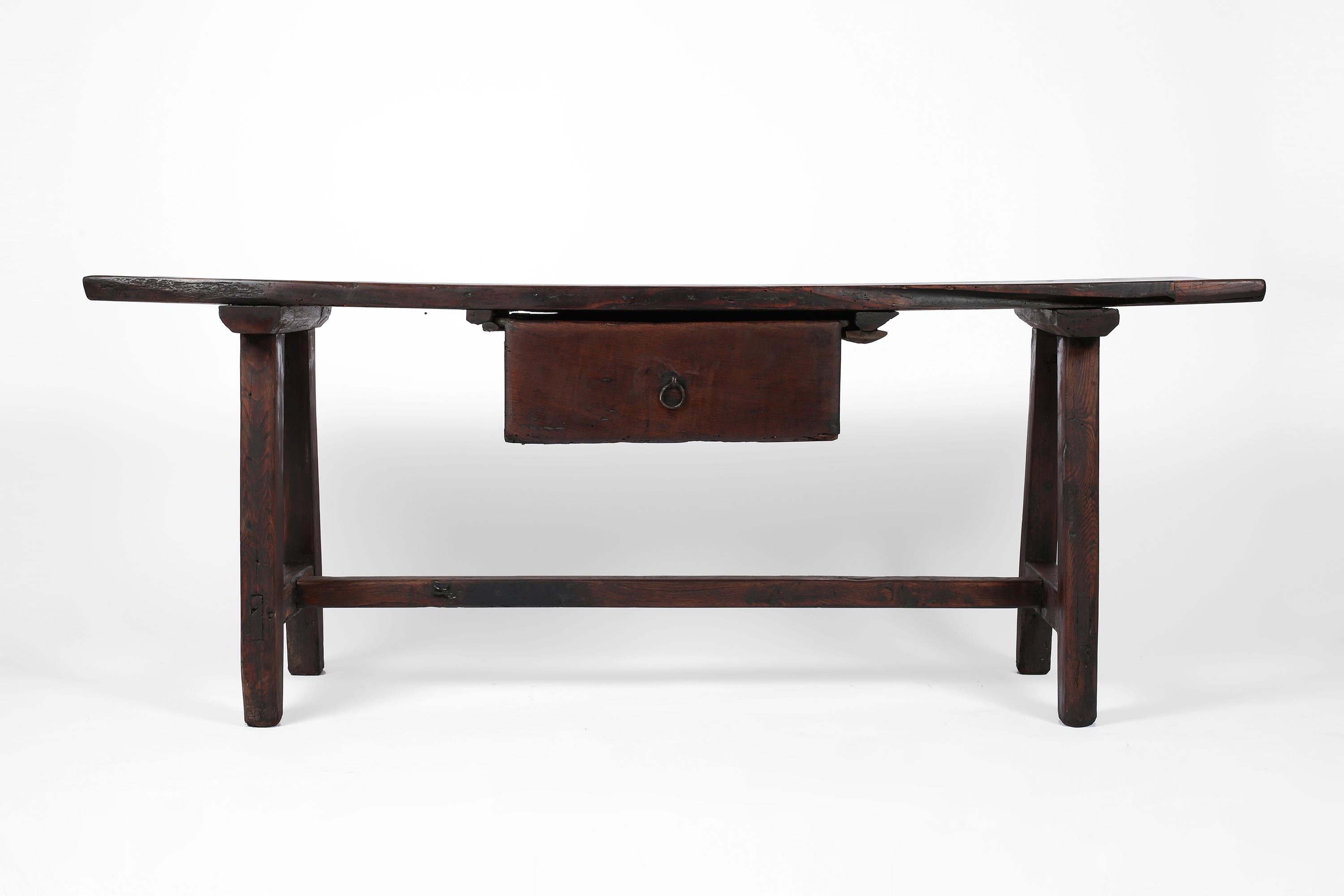 A substantial 18th century console table with a simplistic silhouette, constructed from solid, beautifully patinated chestnut timber. Featuring an impressive single plank top with characterful historic repairs and a large, single drawer with