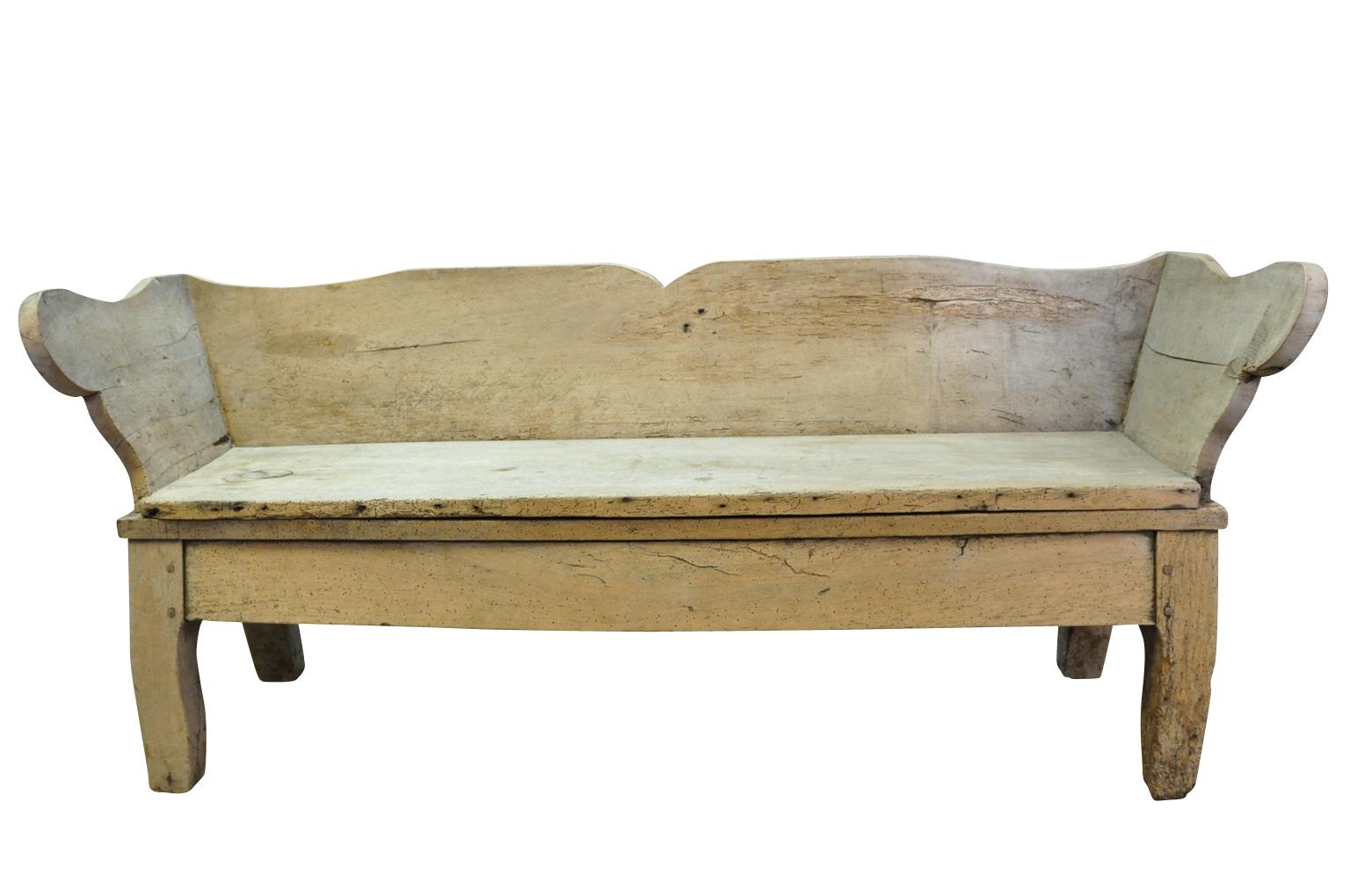 A delightful 18th century primitive bench from the Southwest of France. Wonderfully constructed from naturally washed walnut. Terrific patina. Perfect at the base of a bed, under a picture window, or placed on a porch.