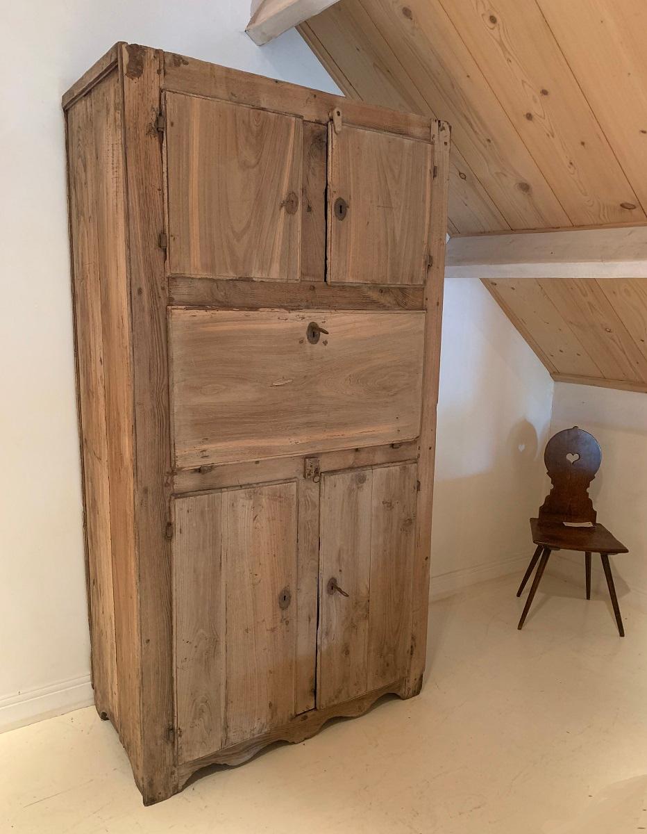 A late 18th century primitive cupboard. Made from chestnut in Spain cupboards like these would have been used for storage of food and supplies. The middle desk was intended to act as a desk to note the supplies in a letcher. Also called a officina