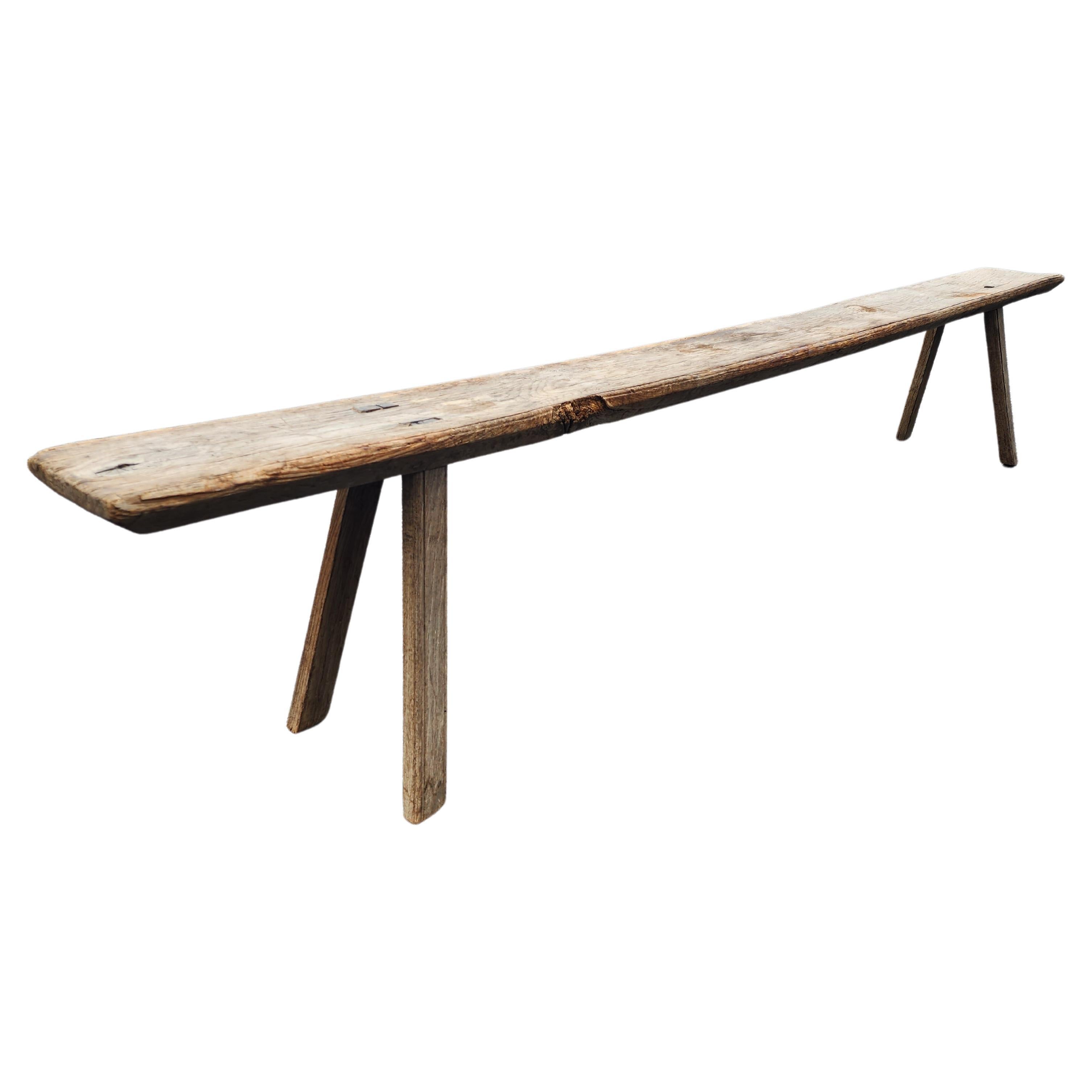 Fantastic french oak bench. Primitive and yet elegant in its simplicity and vernacular design. These benches had many uses, this one coming in at over one hundred inches in length must have had many. But nowadays they make the most excellent