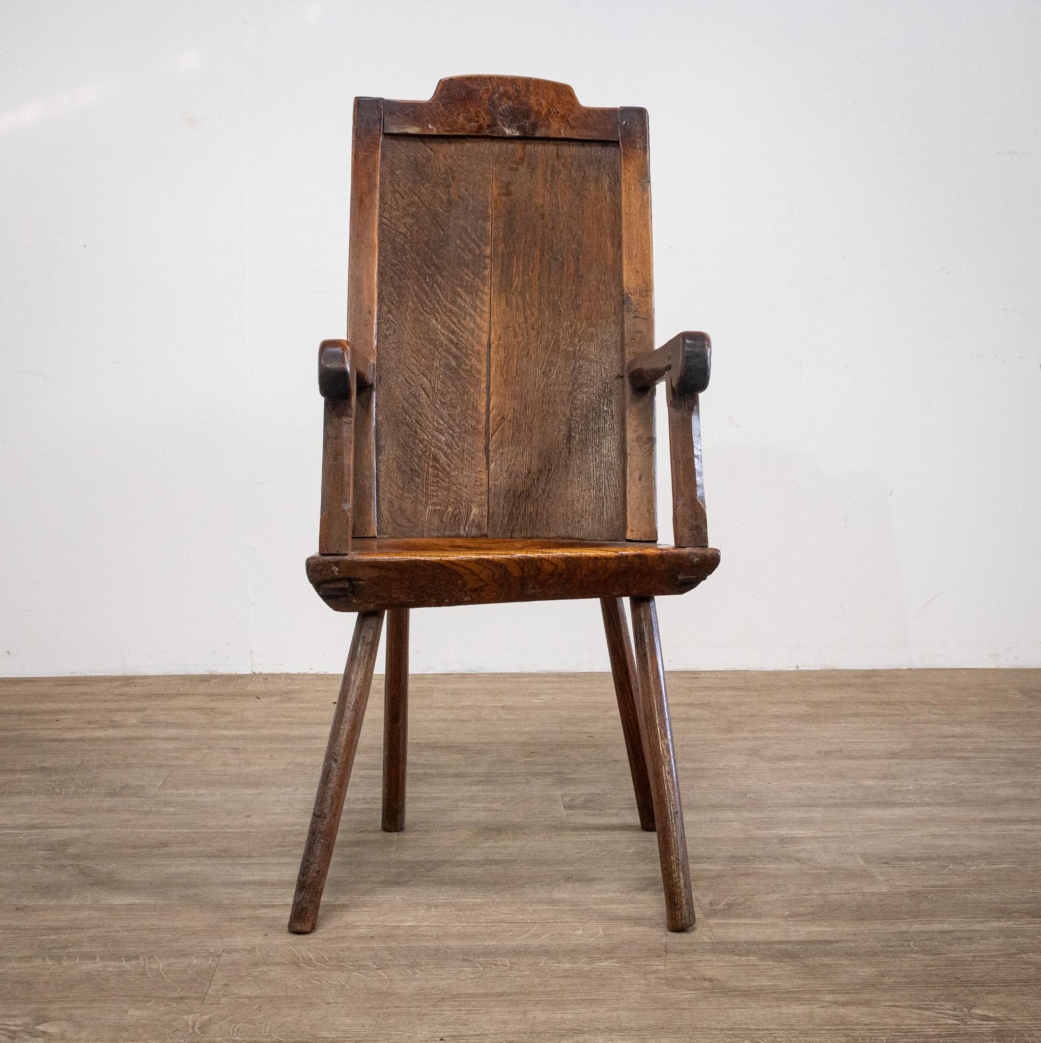 A beautifully simple and rarely available 18th century hand crafted primitive chair, this has a lovely colour and patina to the wood and will make a wonderful statement piece for any room. The seat is made from a thick, solid piece of wood which has