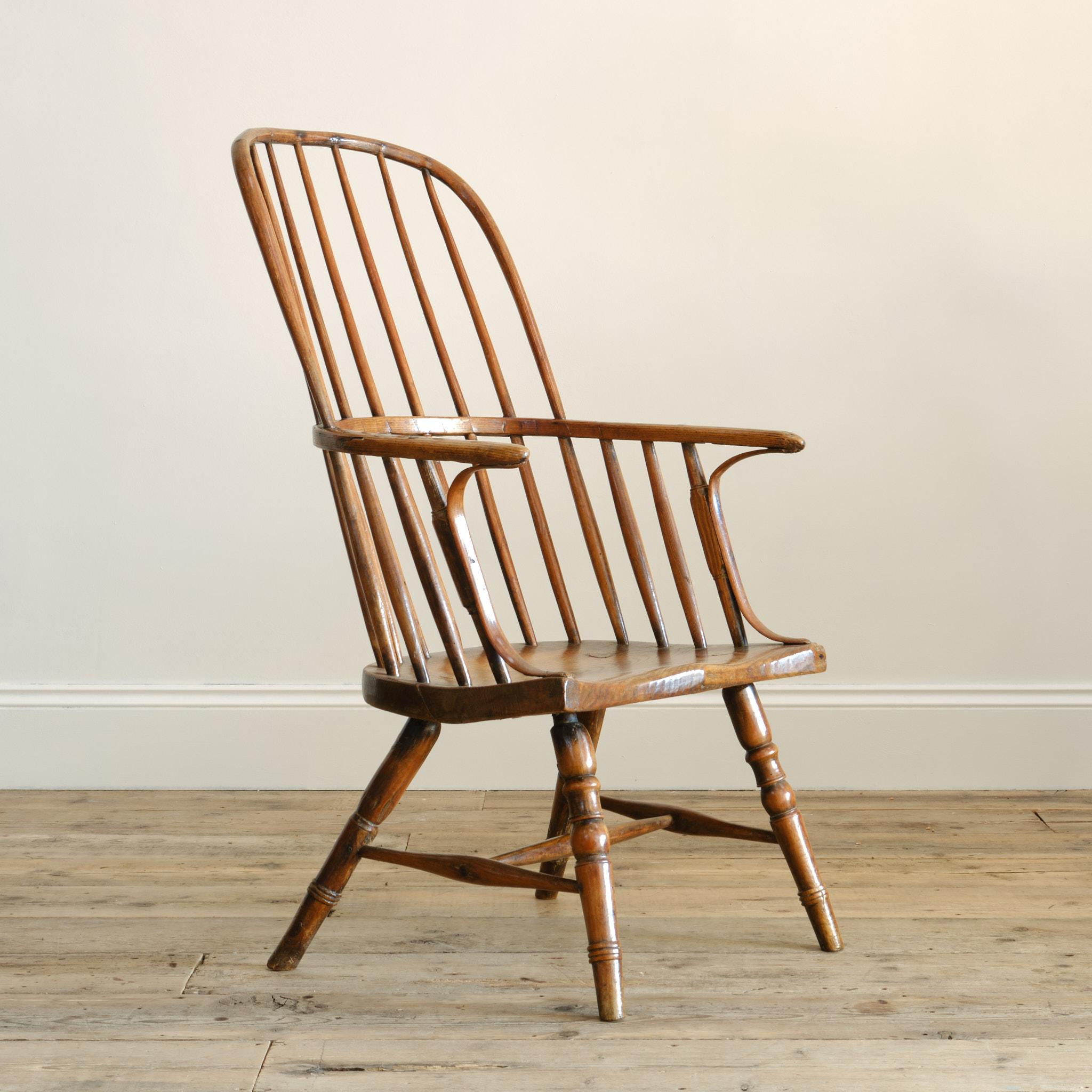 A Vale of York Windsor chair in Ash and Elm. A thick slab seat with chamfered front edge and single piece arm bow with cleft arm support. Raised on turned legs and stretchers. England c 1800

seat height 36cm

Structurally sound. Evidence of