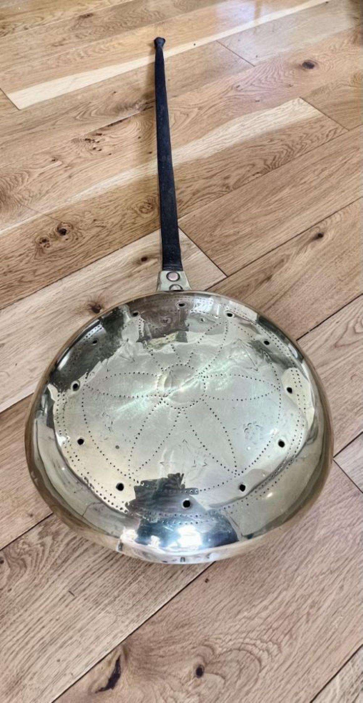 18th century quality brass warming pan having a quality 18th century brass warming pan with the original iron handle 

D. 1770