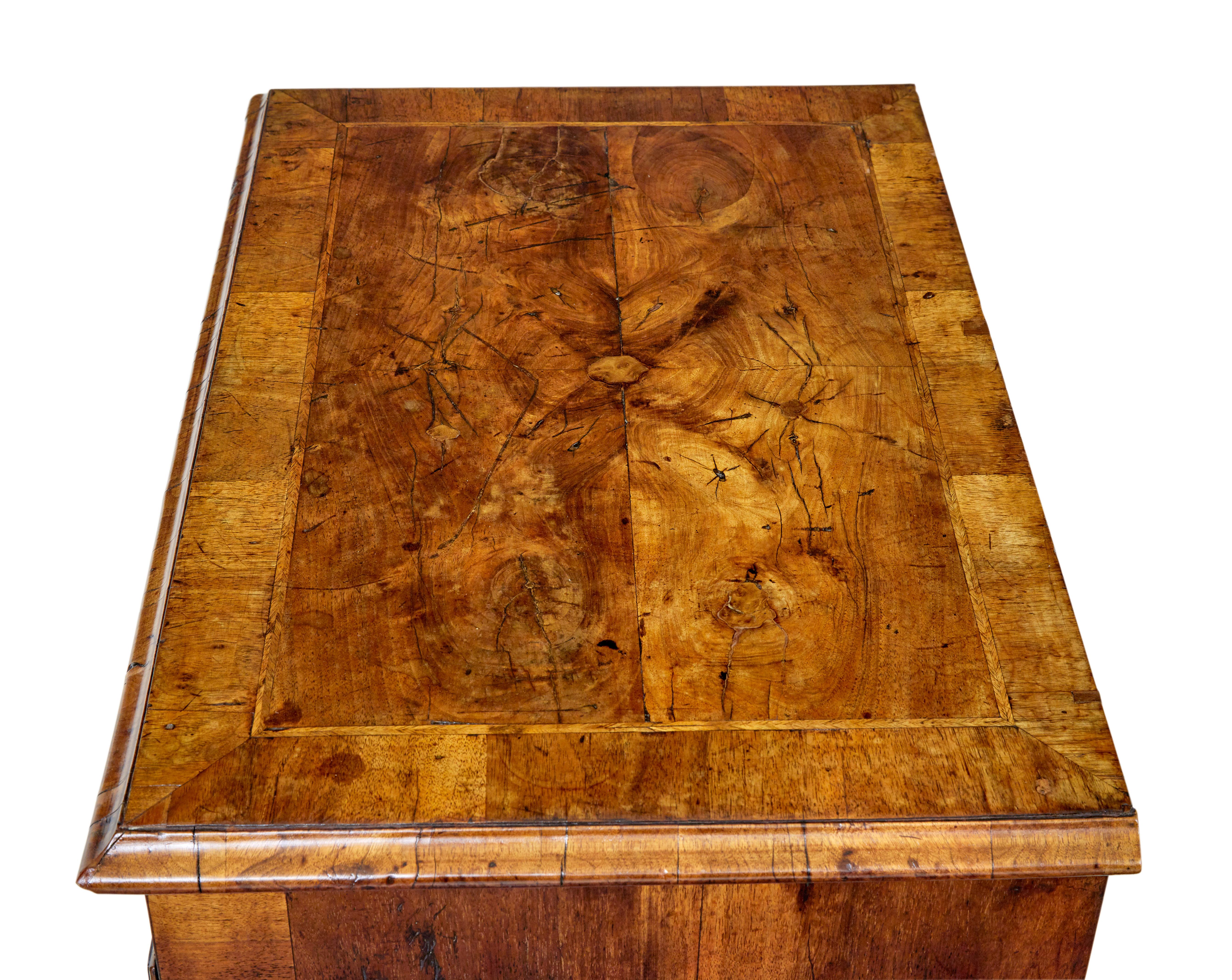 18th century Queen Anne walnut kneehole desk circa 1710.

Good quality knee hole desk of small proportions, richly veneered in burr walnut. Rectangular top, strung and cross banded, finished with a moulded edge. 1 drawer below the top surface and a