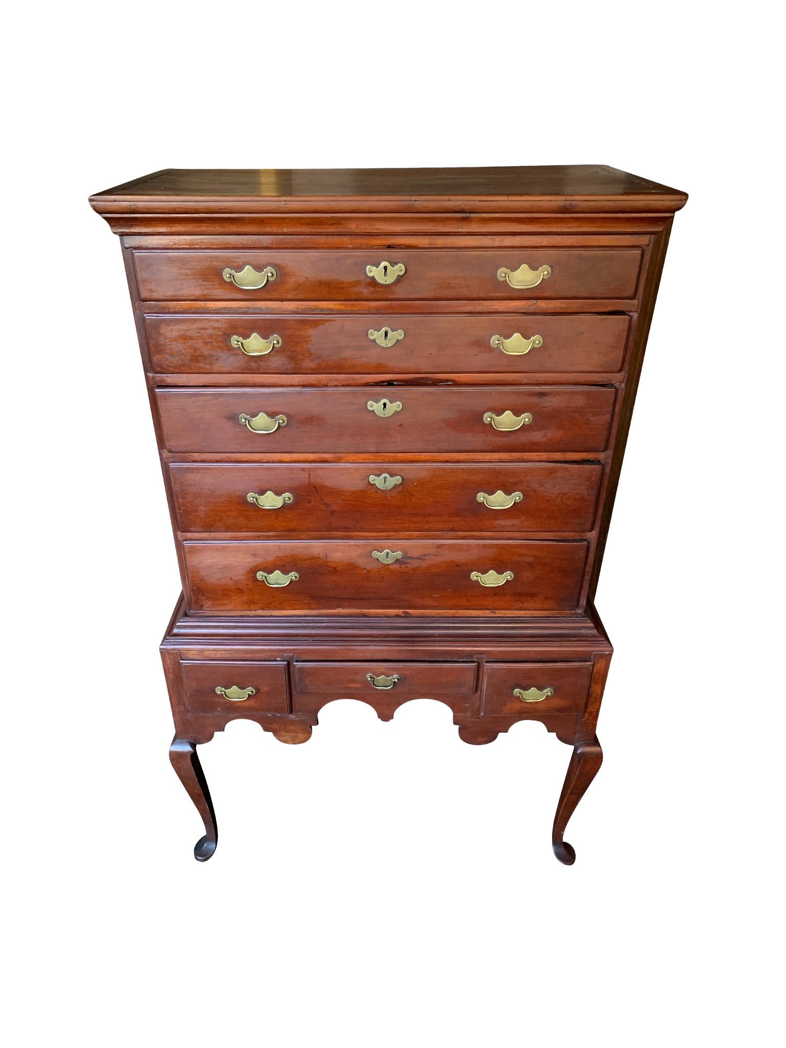 Hand-crafted Queen Anne highboy, circa 1720s. New England. The chest consists of 2 sections made from a lovely combination of cherry and walnut wood. The upper half has 5 full length drawers, while the lower half has 3 small drawers. Each is