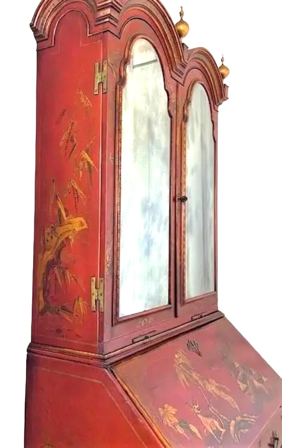 A museum quality fine antique for your special home. The bookcase with duel arched molded hood is surmounted by three turned urn-form finials above a straight case fitted with a pair of beveled mirror hinged doors with serpentine tops above two