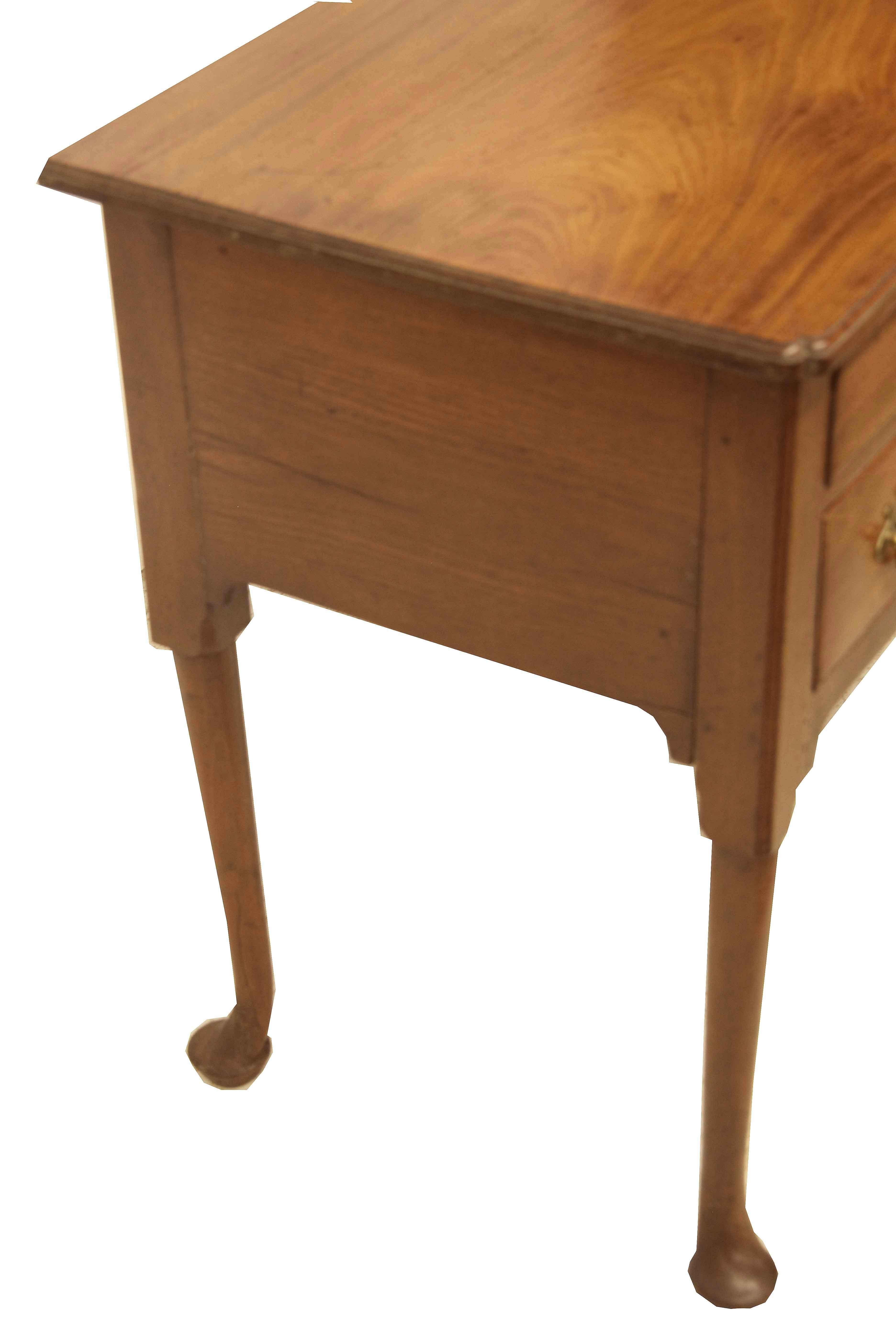 18th century Queen Anne lowboy, the swirl grain top has a beautiful faded color and patina with a molded edge and ''pinched'' front corners. The drawers have reticulated brass pulls and escutcheon, incised line molding. The nicely shaped legs