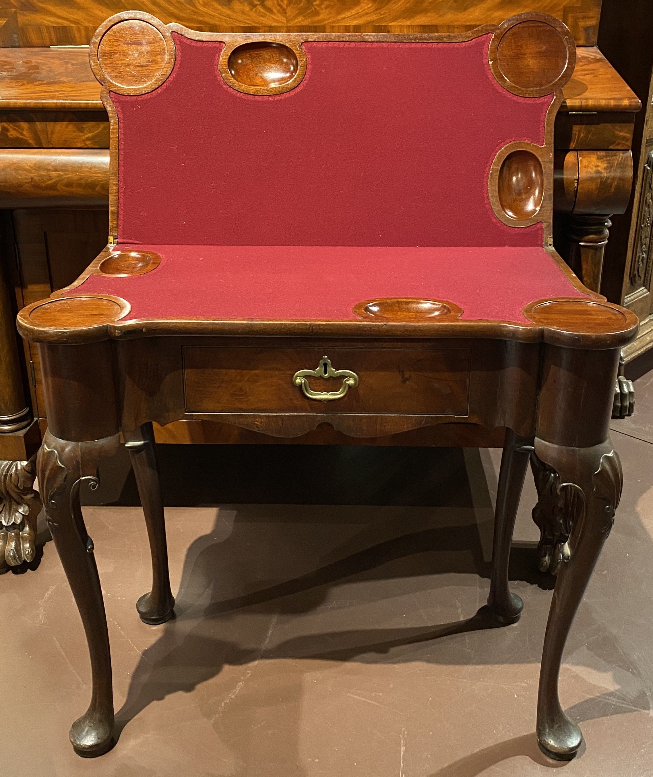 A nice example of an English Queen Anne mahogany hand carved card or game table with shell carved cabriole legs with pad feet, single frieze drawer with original hardware. Opens to reveal a baize or felt top with carved counter wells. The card table