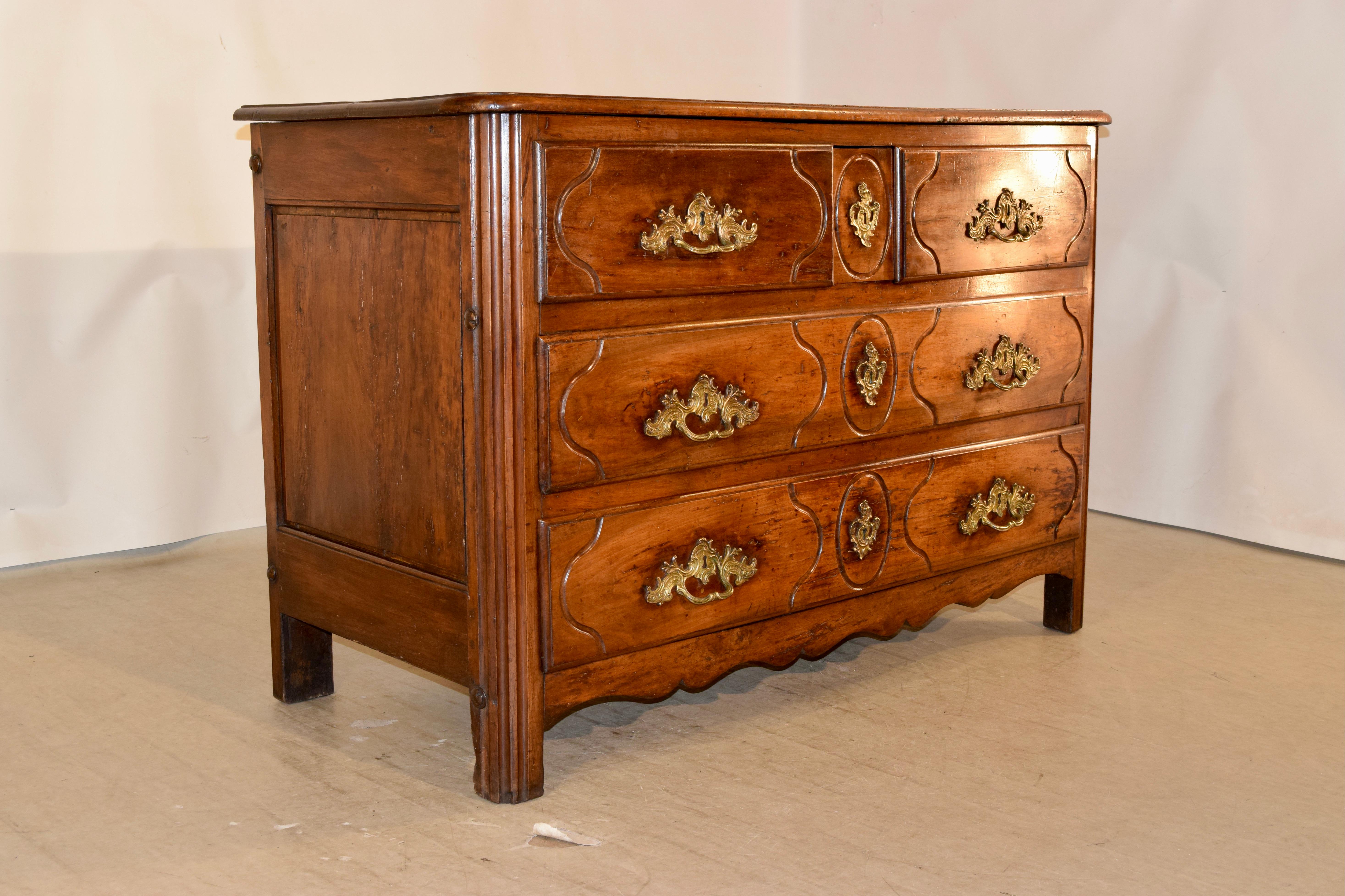18th century rare campaign commode from France that breaks down completely flat for moving. The top is beveled around the edge over hand paneled sides and two drawers over two drawers, all with beveled edges and carved decorated drawer fronts and