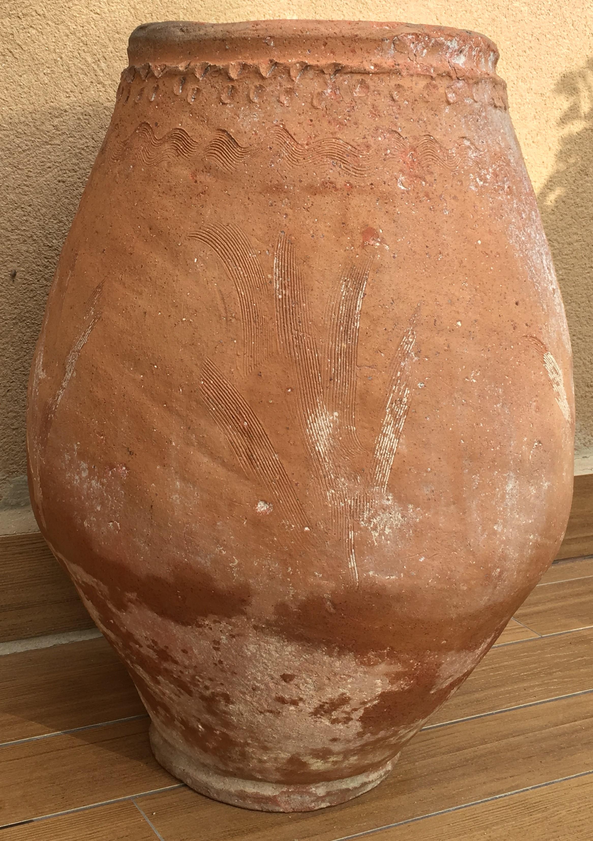 This fabulous handmade terracotta pot originated in the Provençal town of Biot and was used to store olive oil. The interior glaze that extends to around the rim was used to prevent vermin from climbing into the oil inside. In perfect condition, the