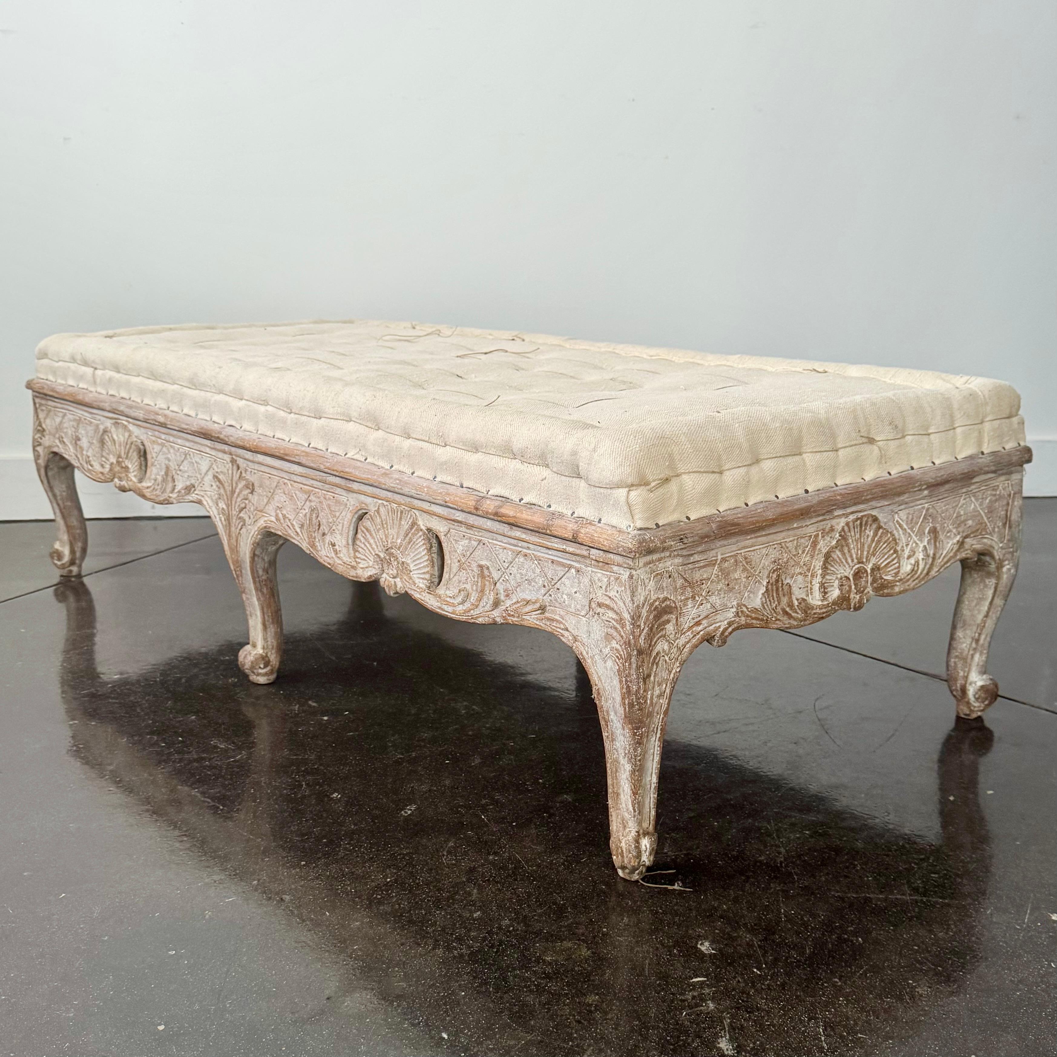 An exquisite, rare 18th century period Rococo sofa bench/stool with hand-carved and richly decorated in scrolling carvings to three sides,
Scraped to original cream white finish and upholstered in traditional way in antique hand stitched linen.
