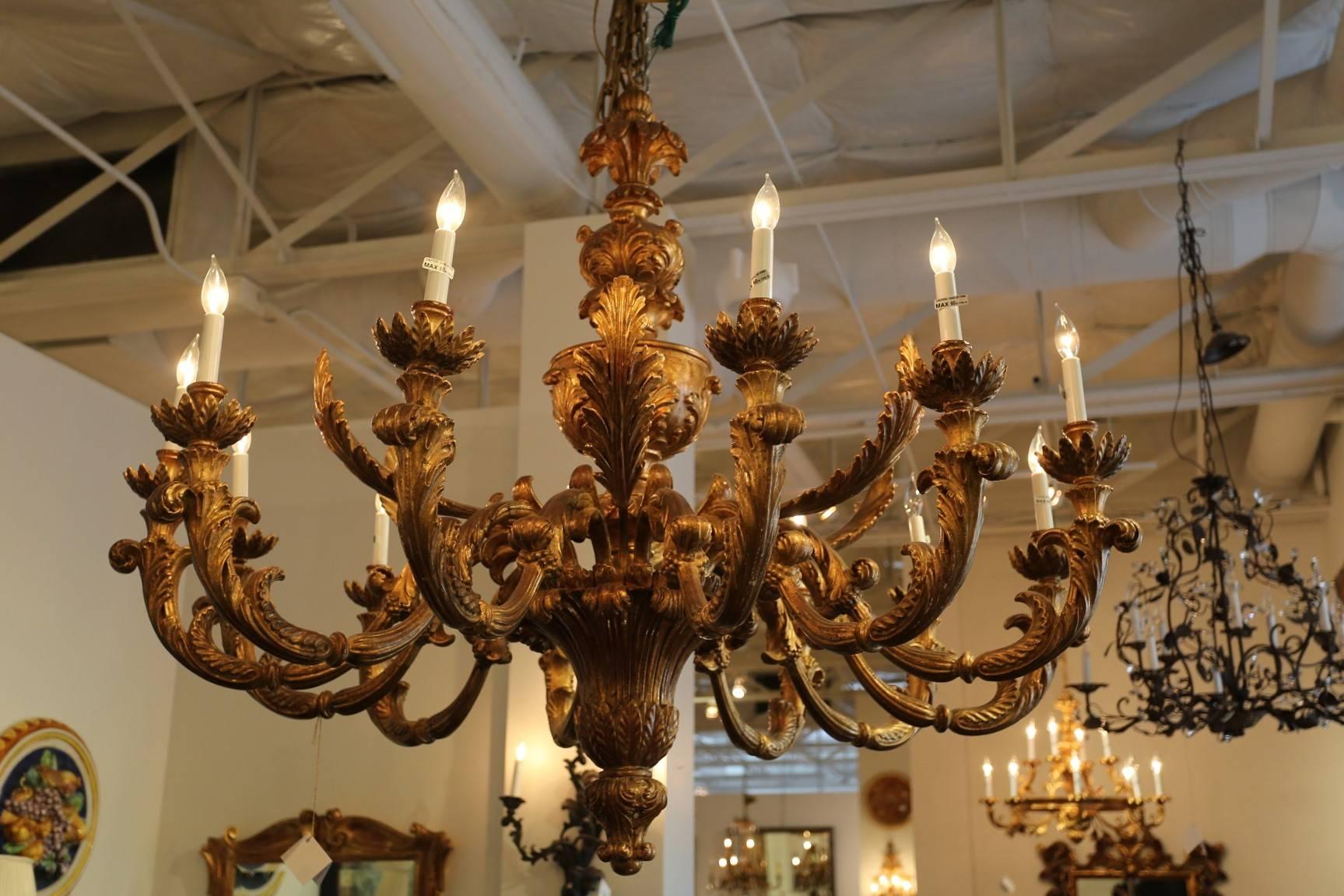 This grand 18th century Renaissance style recreation of an exquisite hand-carved one-tier chandelier with 12 lights measures an impressive 56 inches across and 48