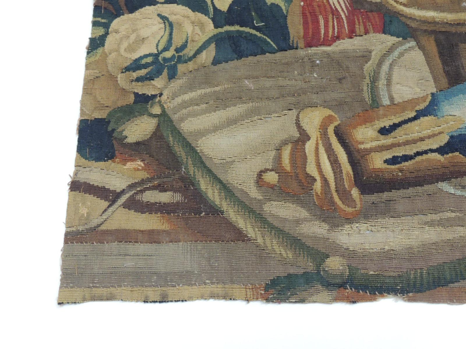 This fragment depicts archery and hunting instruments on top of a cushion.
Tassels, flowers cups and vines are depicted throughout. In shades of gold, green, blue, red, yellow and brown.
Ideal for the centre of a pillow or to frame it in a shadow