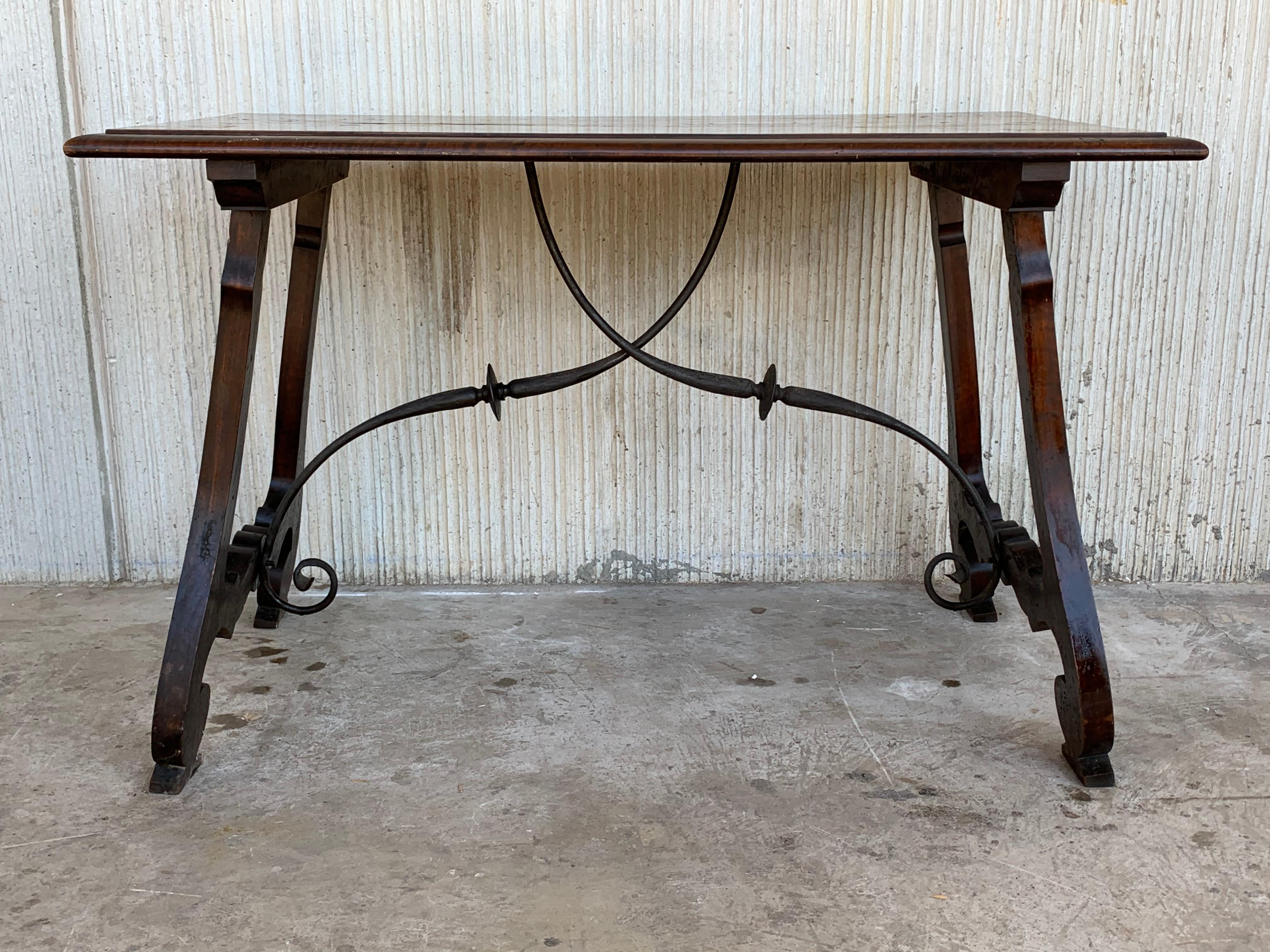 18th century Catalonian dining table with Baroque style lyre legs

This Spanish 18th century table features a rectangular top over an exquisite trestle type base with lyre shaped legs raised on carved volutes. Big thickness of the plateau and