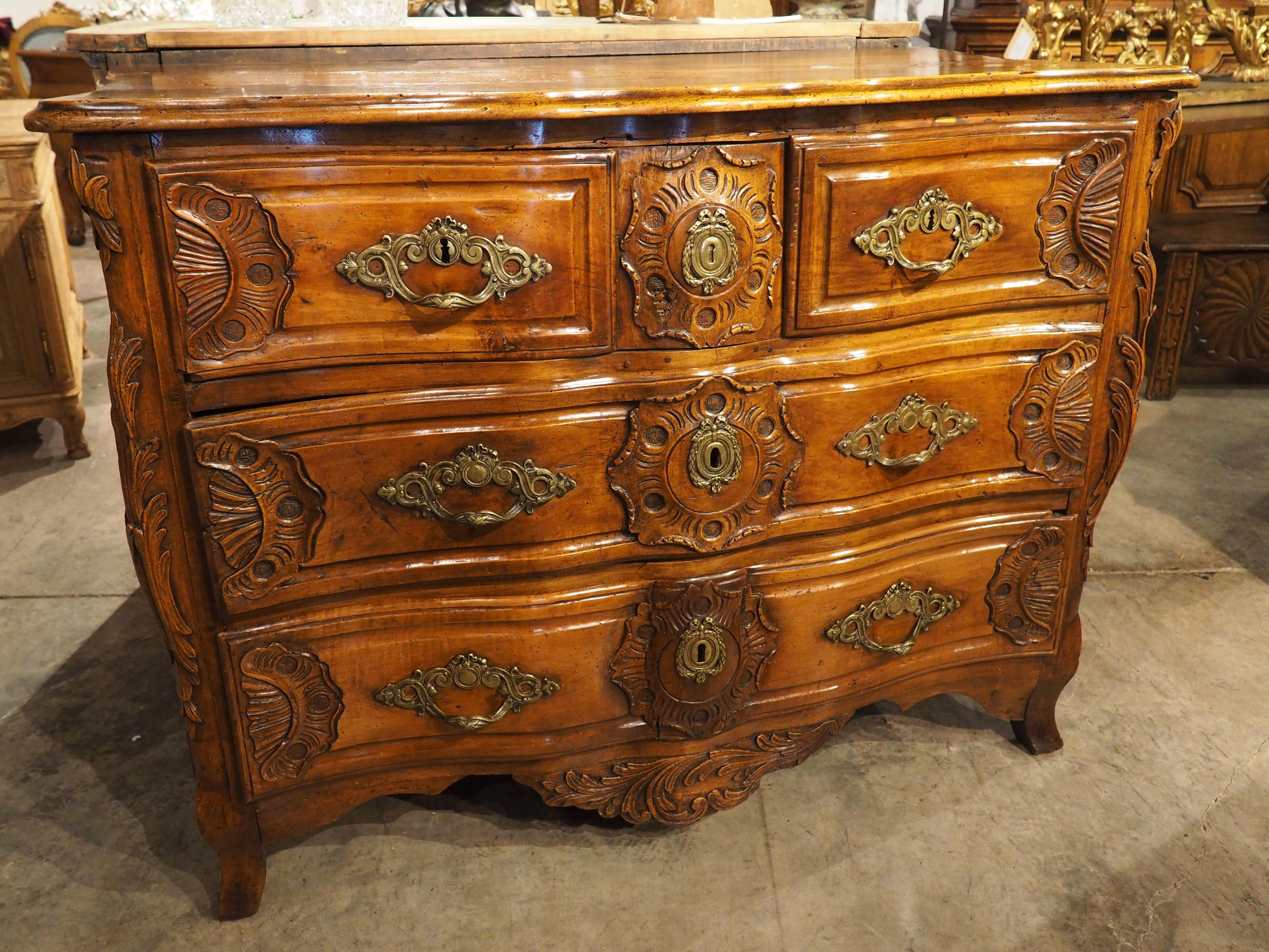 Furniture from the Regence period of the early 1700s incorporates elements from the reigns of Louis XIV and Louis XV, the preceding and subsequent styles, respectively. A beautiful example of this balance can be seen in our hand-carved walnut