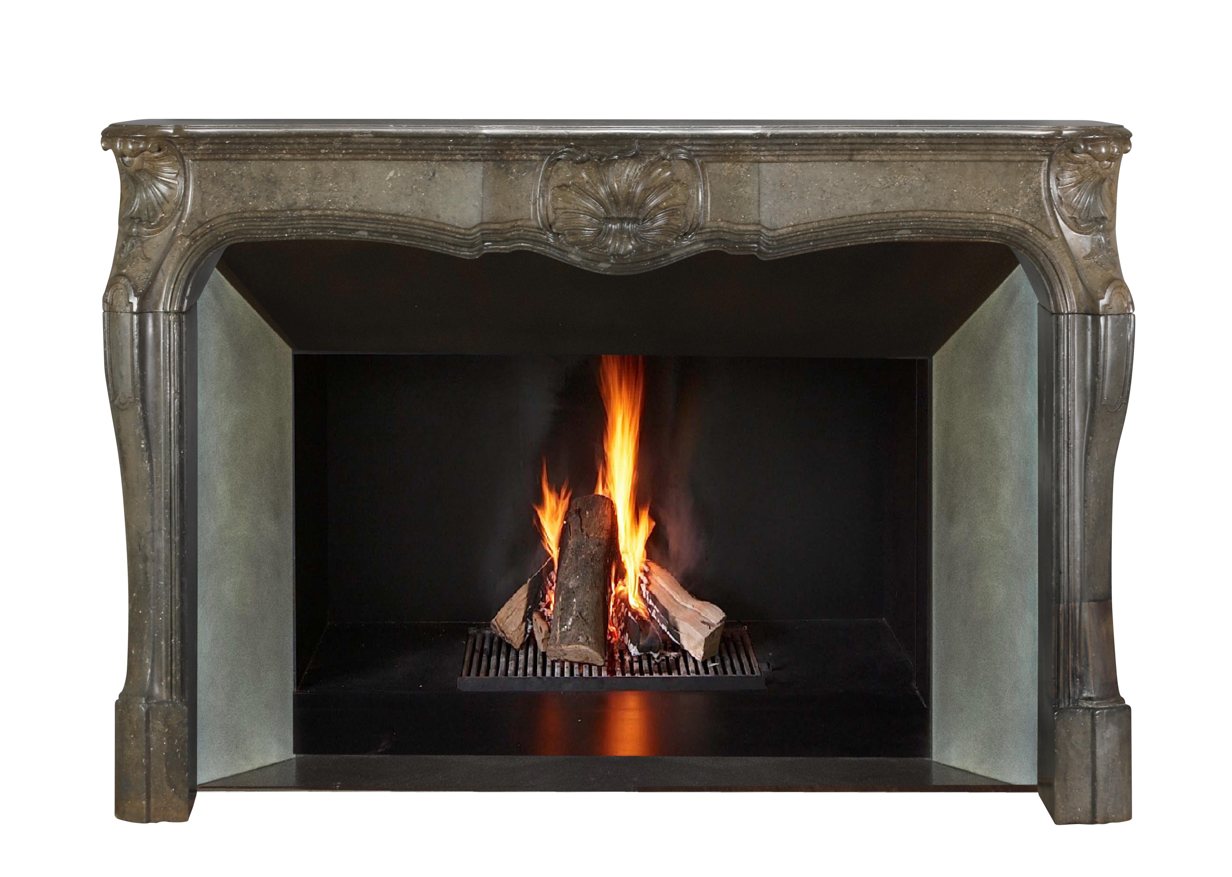 Exquisite antique French fireplace mantel in oxidated stone.
Sculpted with meticulous attention to detail in the 18th century, this surround boasts intricate carvings that exude elegance and sophistication. The timeless design and colour of this